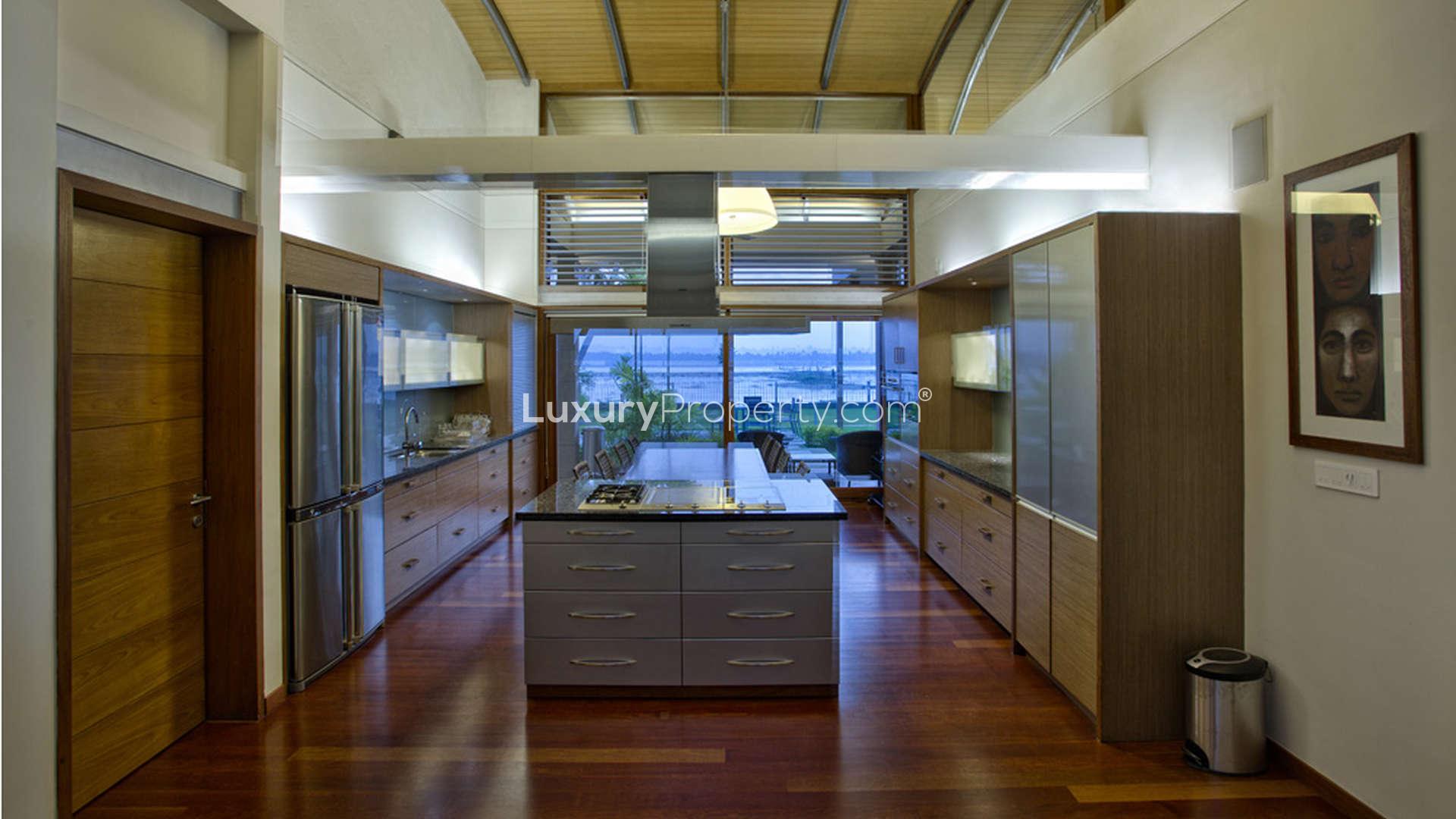 Modern kitchen interior with waterfront view in Kochi villa, The Kariath Residence