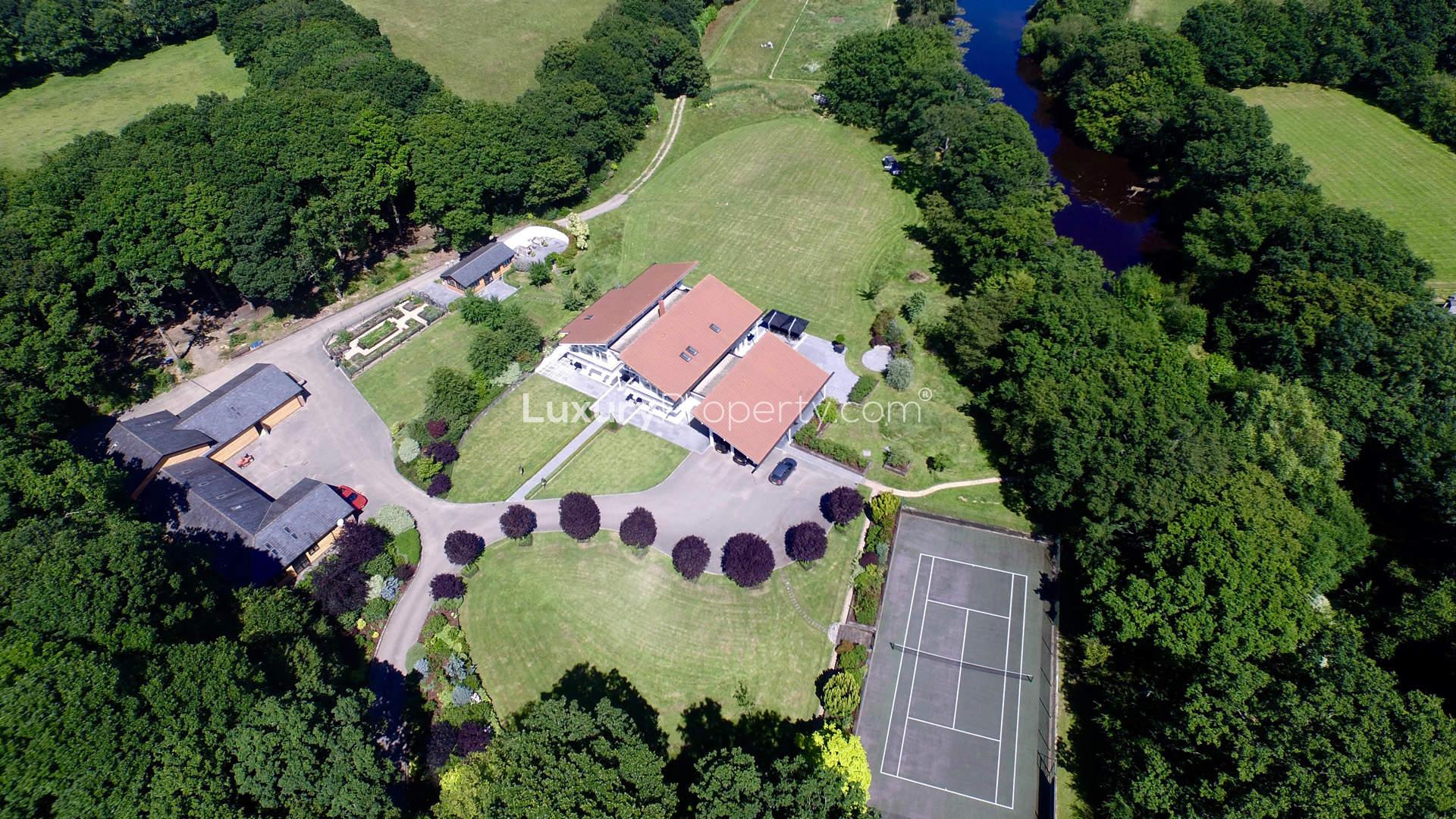 Aerial view of luxurious lake house villa for sale in Sussex, near London