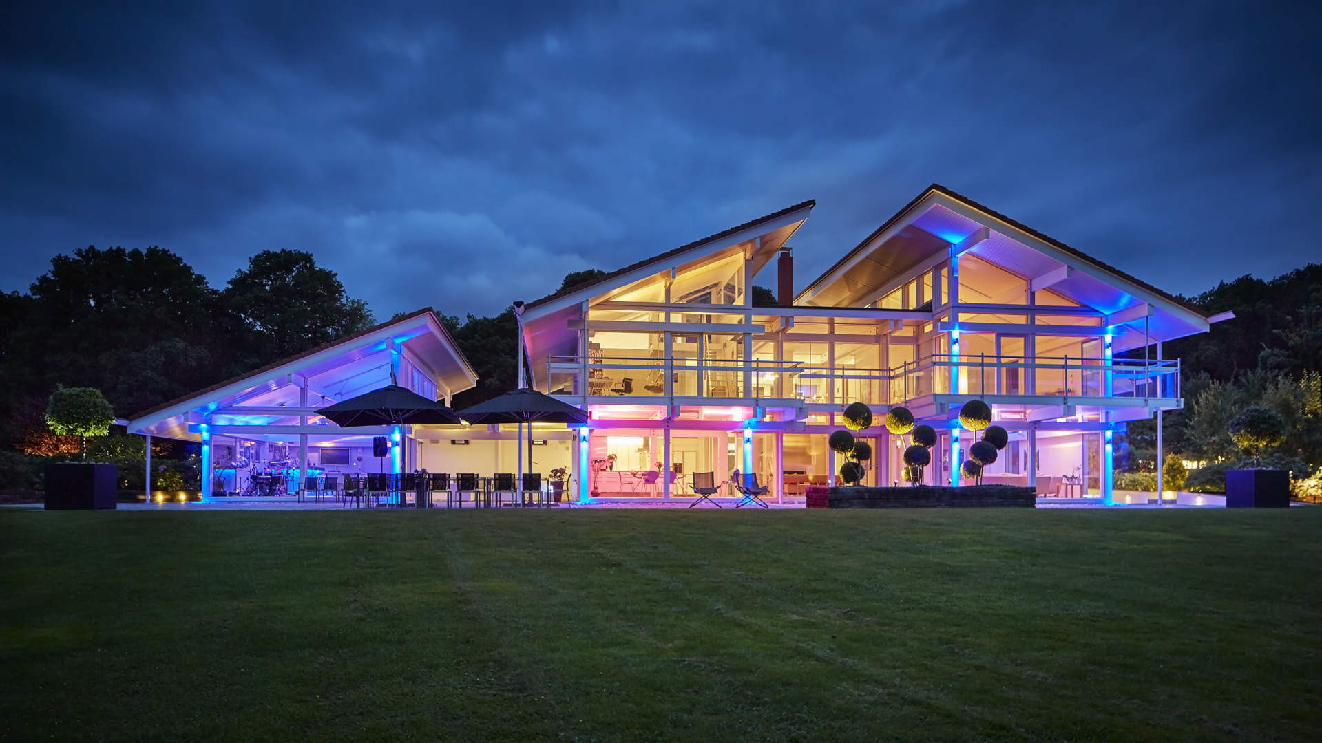 Aerial view of luxurious lake house villa with tennis court in Sussex, near London