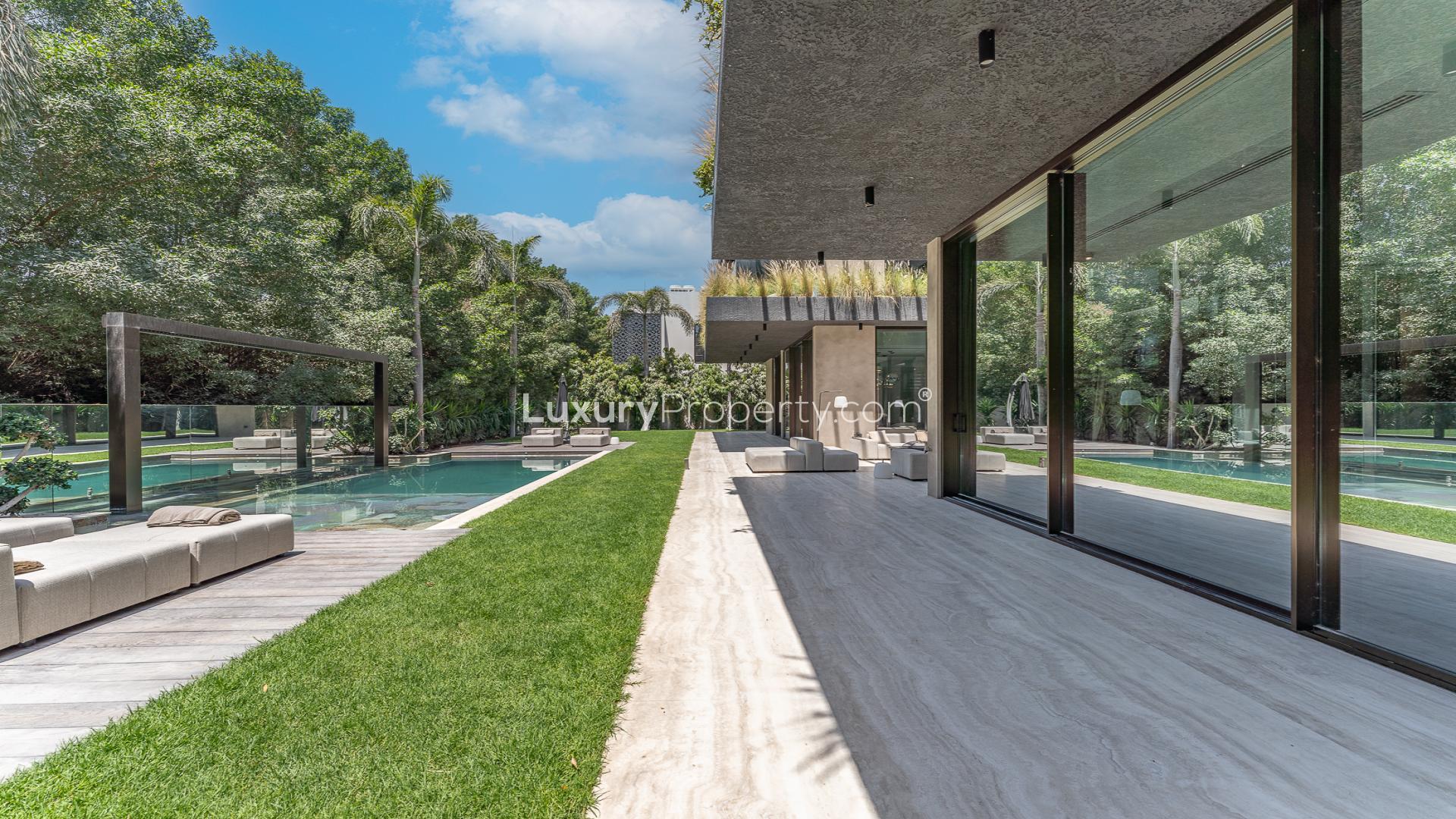 Outdoor seating and pool area of luxury villa in Al Barari's The Collection community