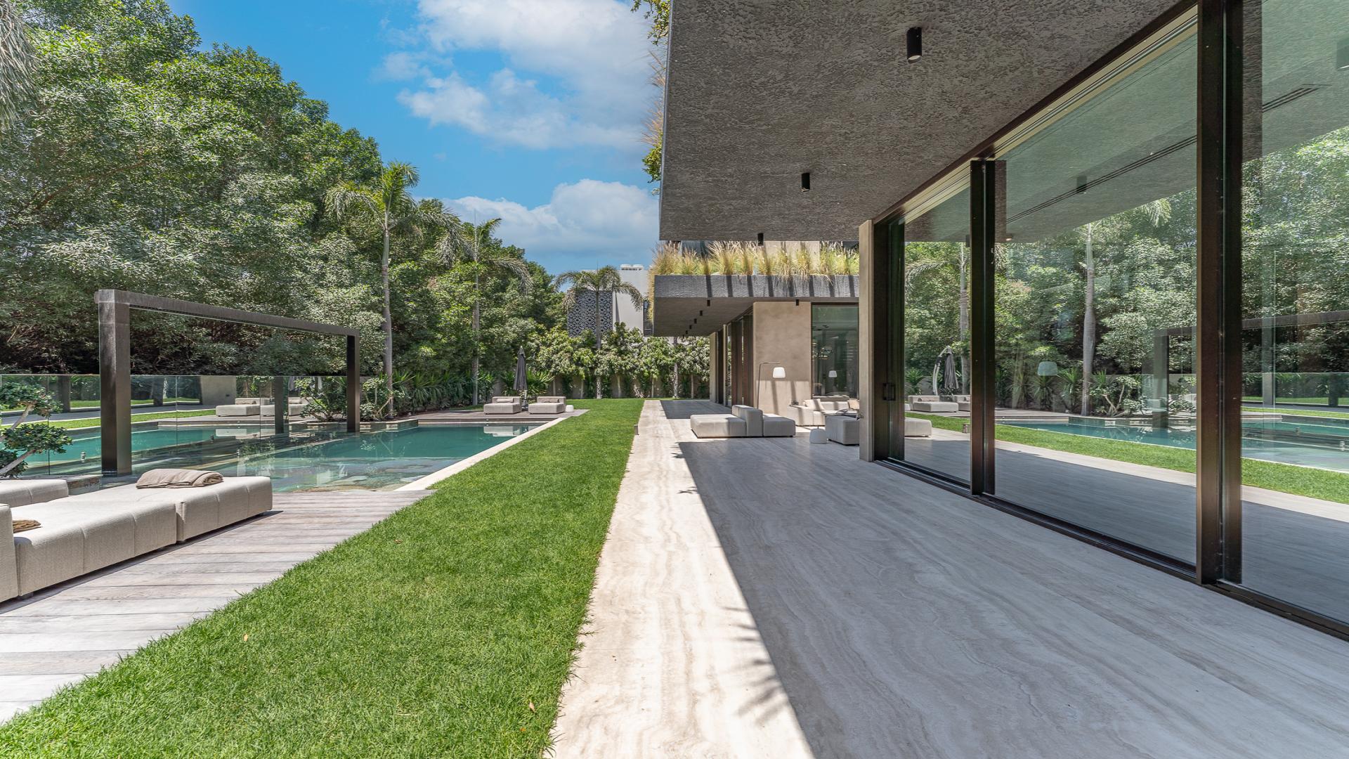 Outdoor seating and pool area of luxury villa in Al Barari's The Collection community