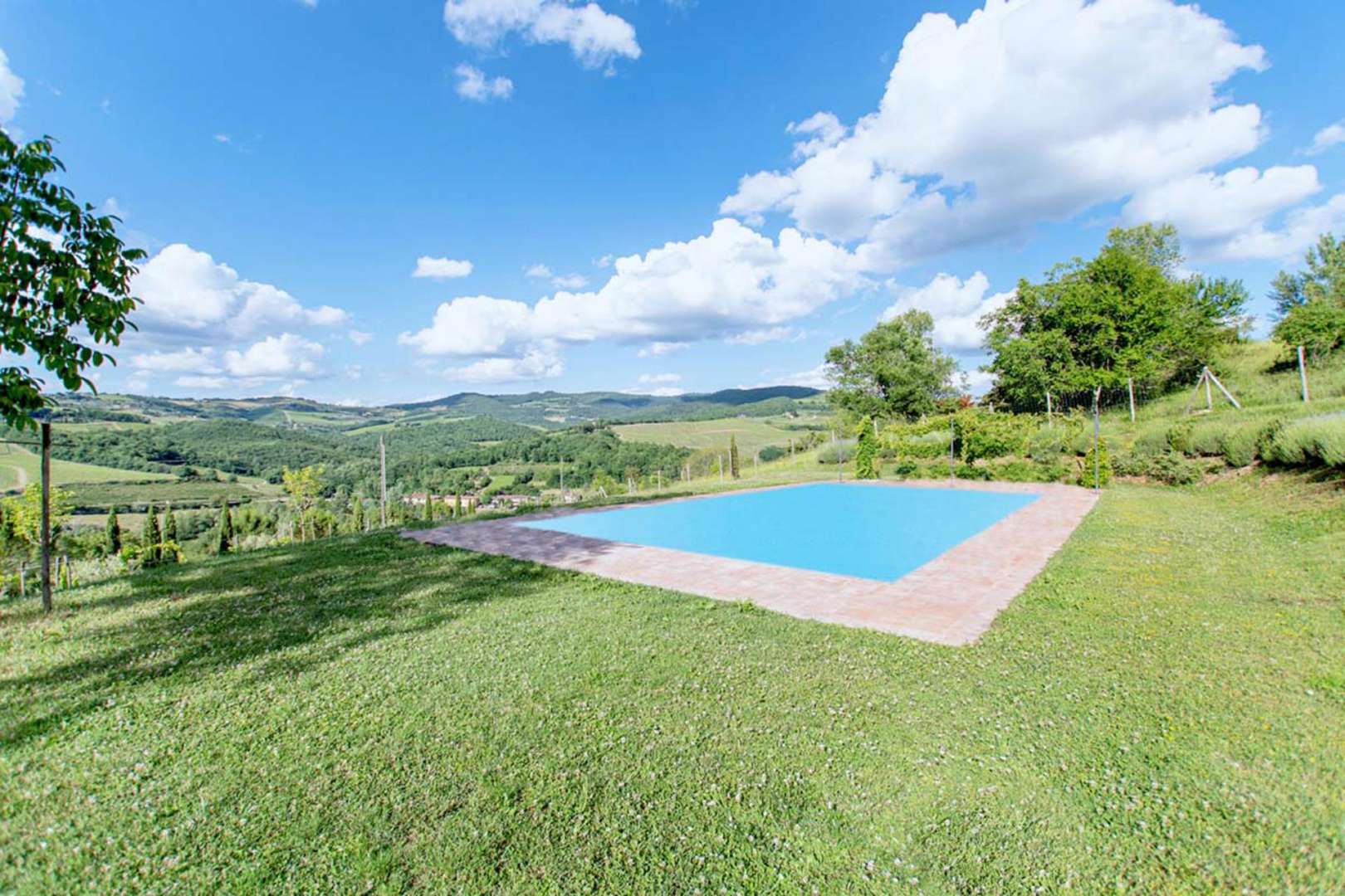 Outdoor seating area with scenic countryside views at farmhouse villa near Panzano, Florence