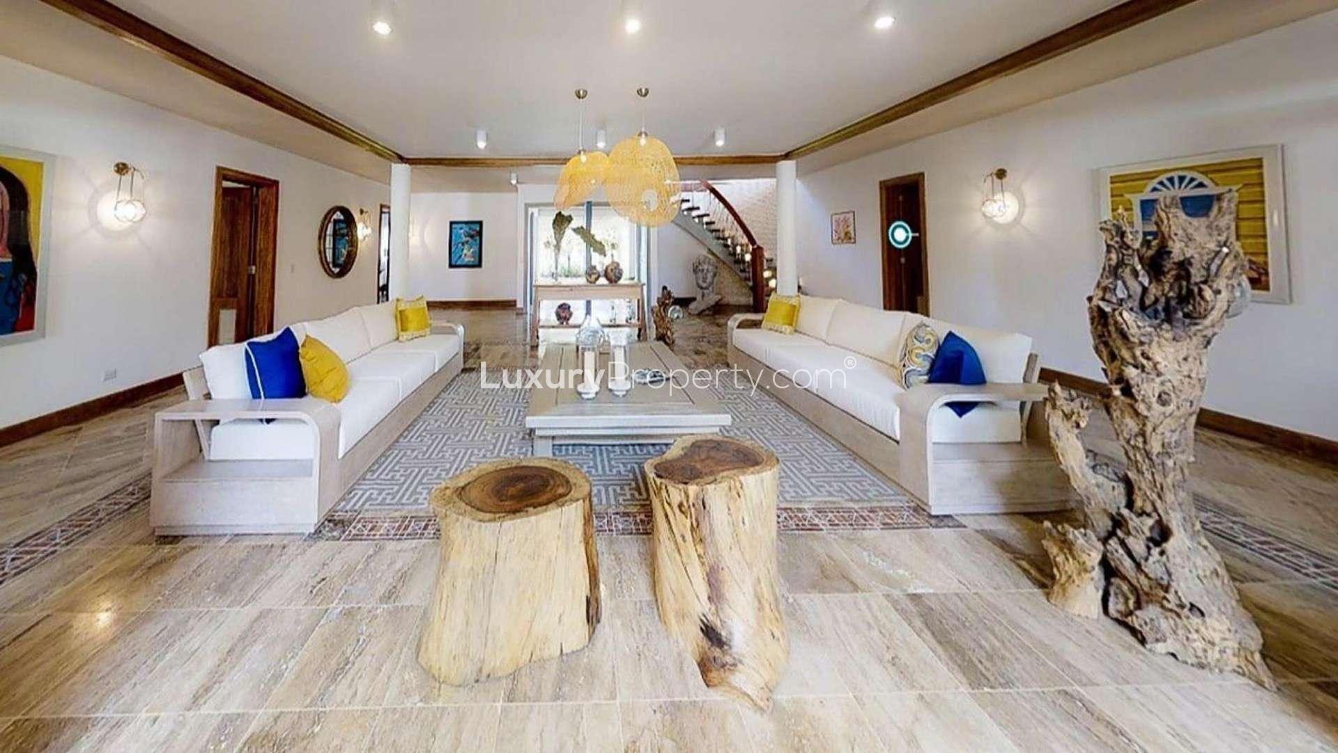 Entrance of luxury Punta Cana villa with hanging plants and stone pathway, Cap Cana