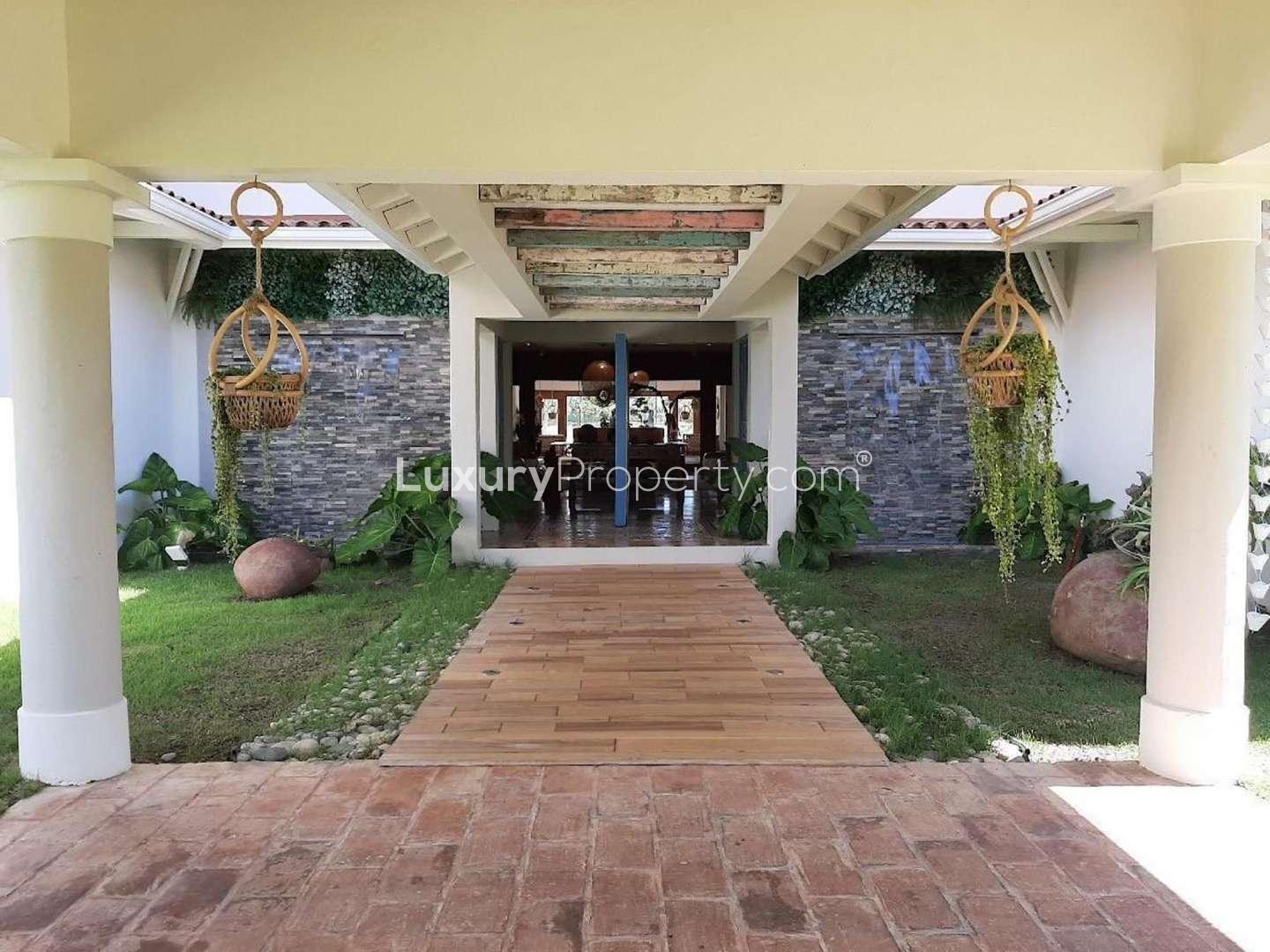 Luxury Punta Cana villa with pool, lush gardens, and spacious outdoor living area for sale
