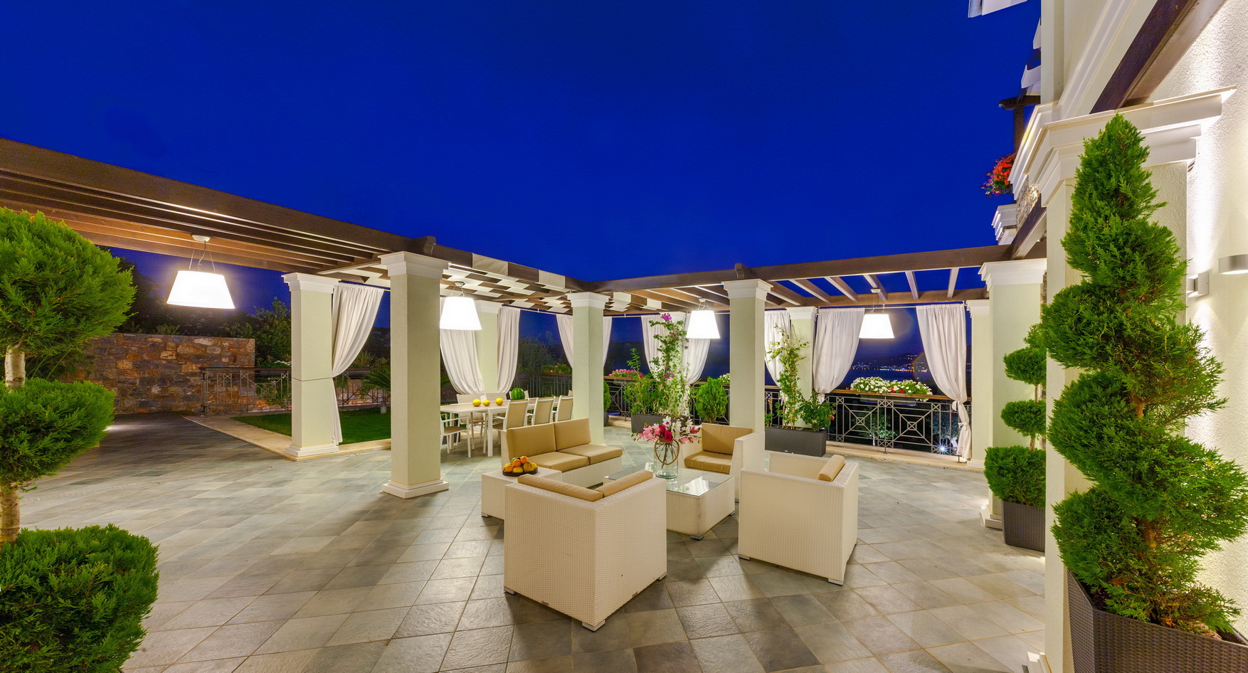 "Stunning Crete villa with pool and mountain views at dusk, Villa Helena beachfront property.",Luxurious outdoor seating area at beachfront villa in Crete, Villa Helena, for sale