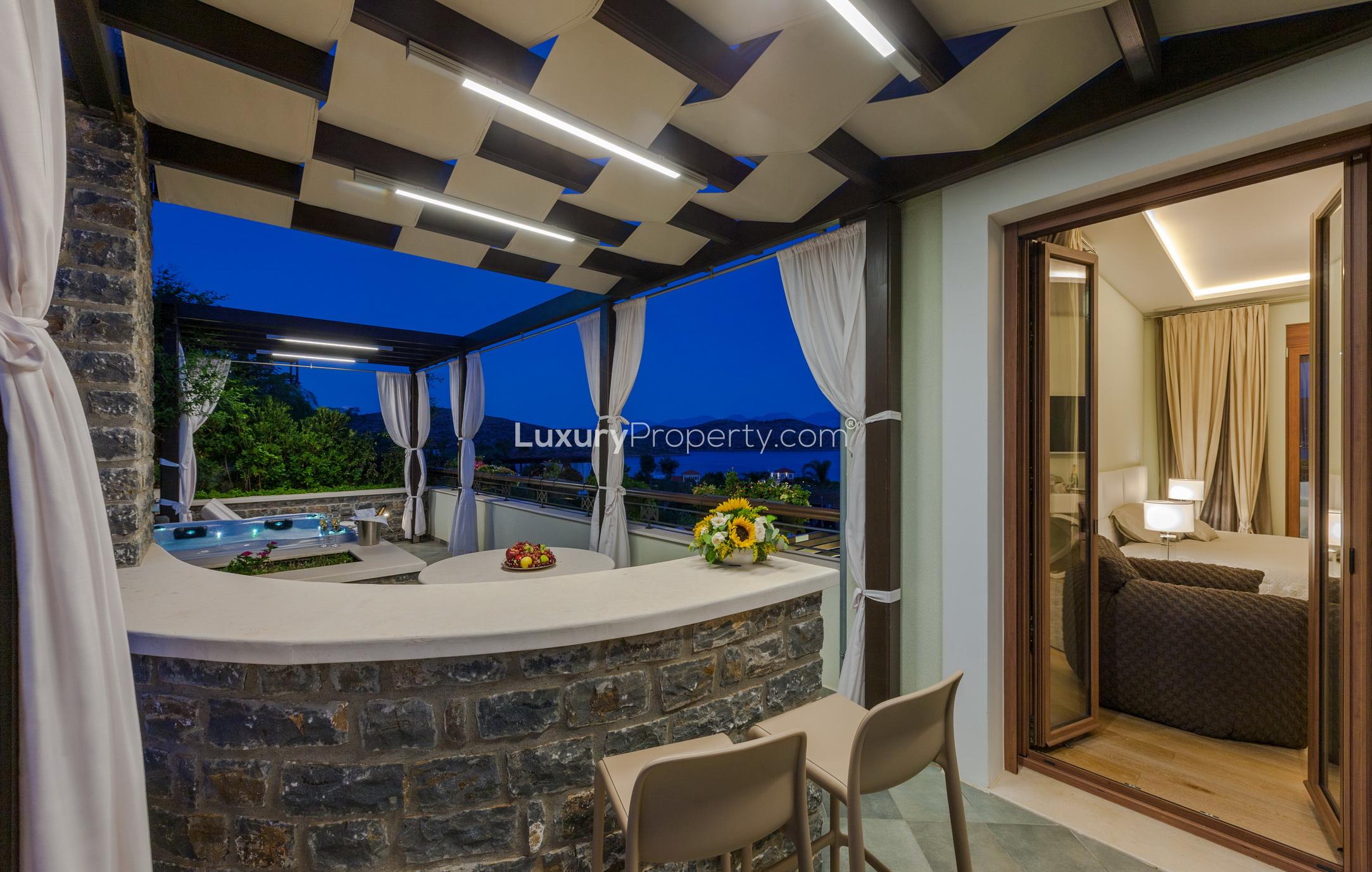 Outdoor patio with bar and sea view at Greek beachfront villa, Crete