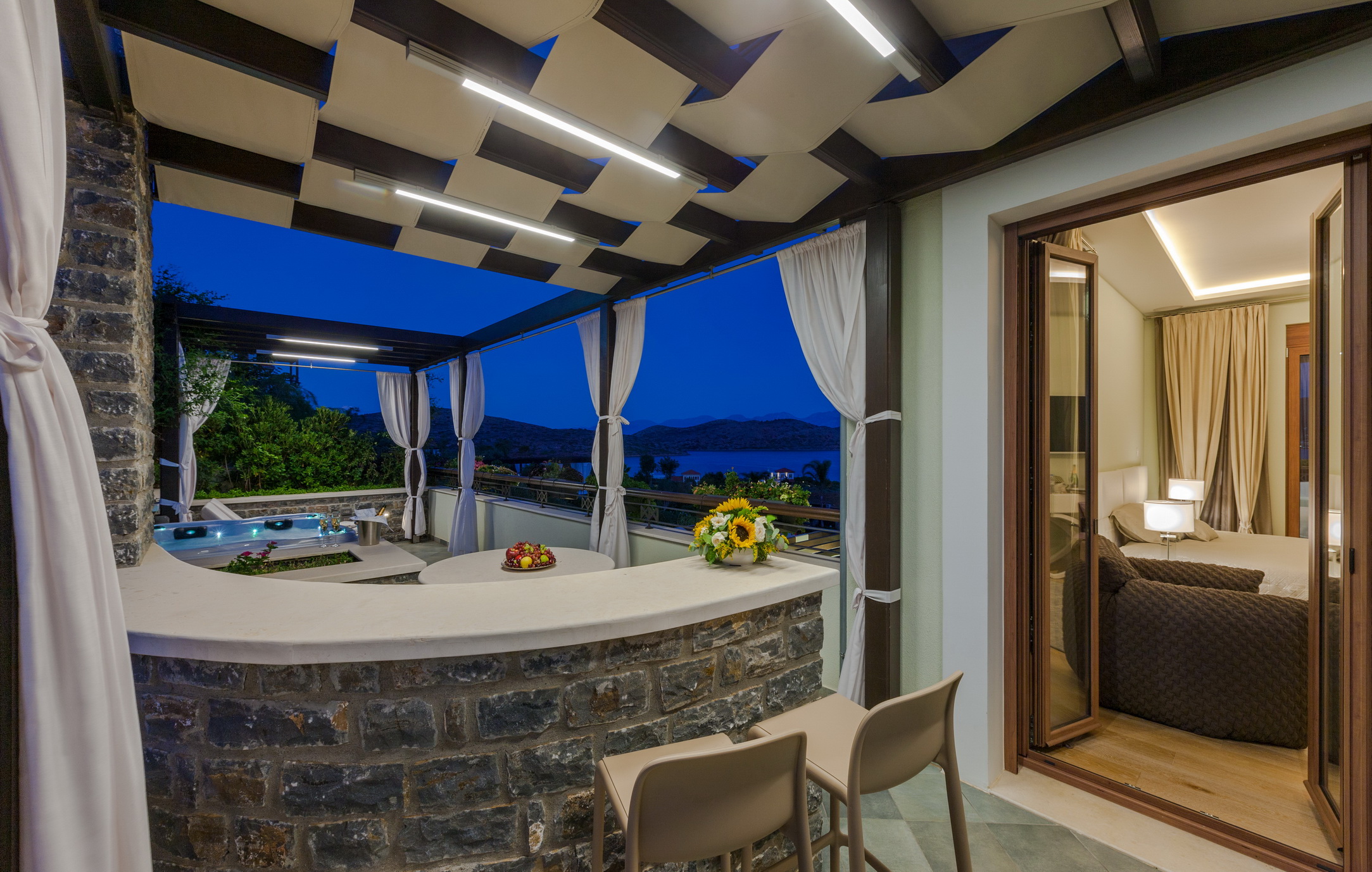 Outdoor patio with bar and sea view at Greek beachfront villa, Crete