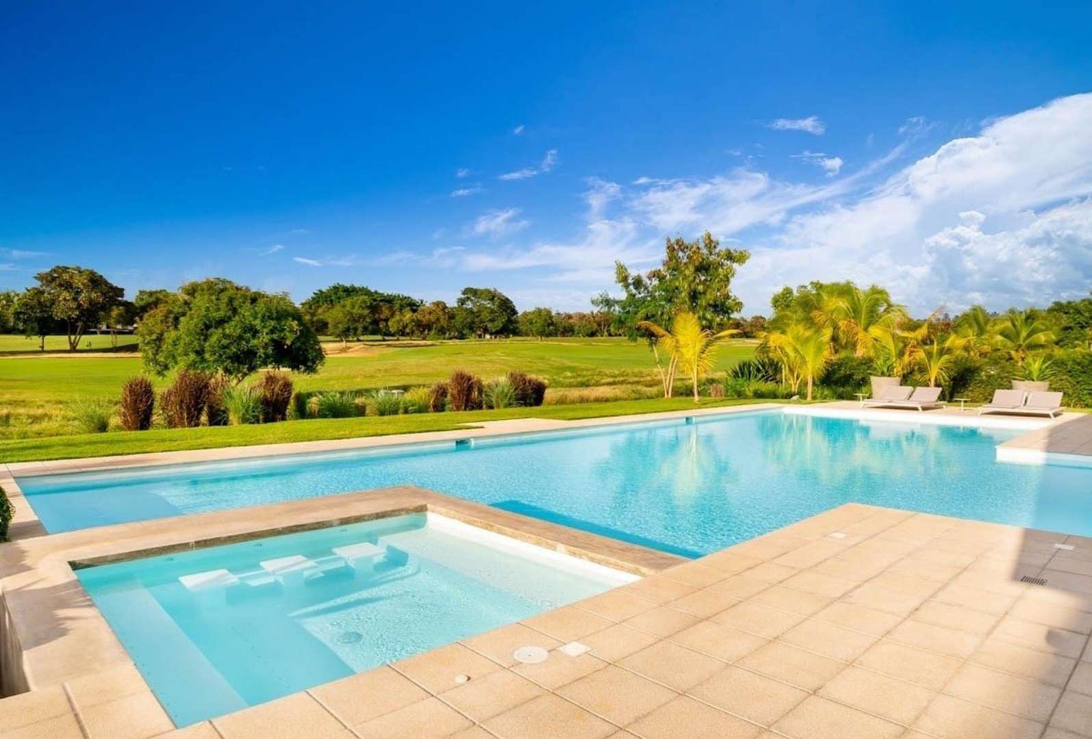 Outdoor dining area with pool view at luxury villa in Casa de Campo, La Romana