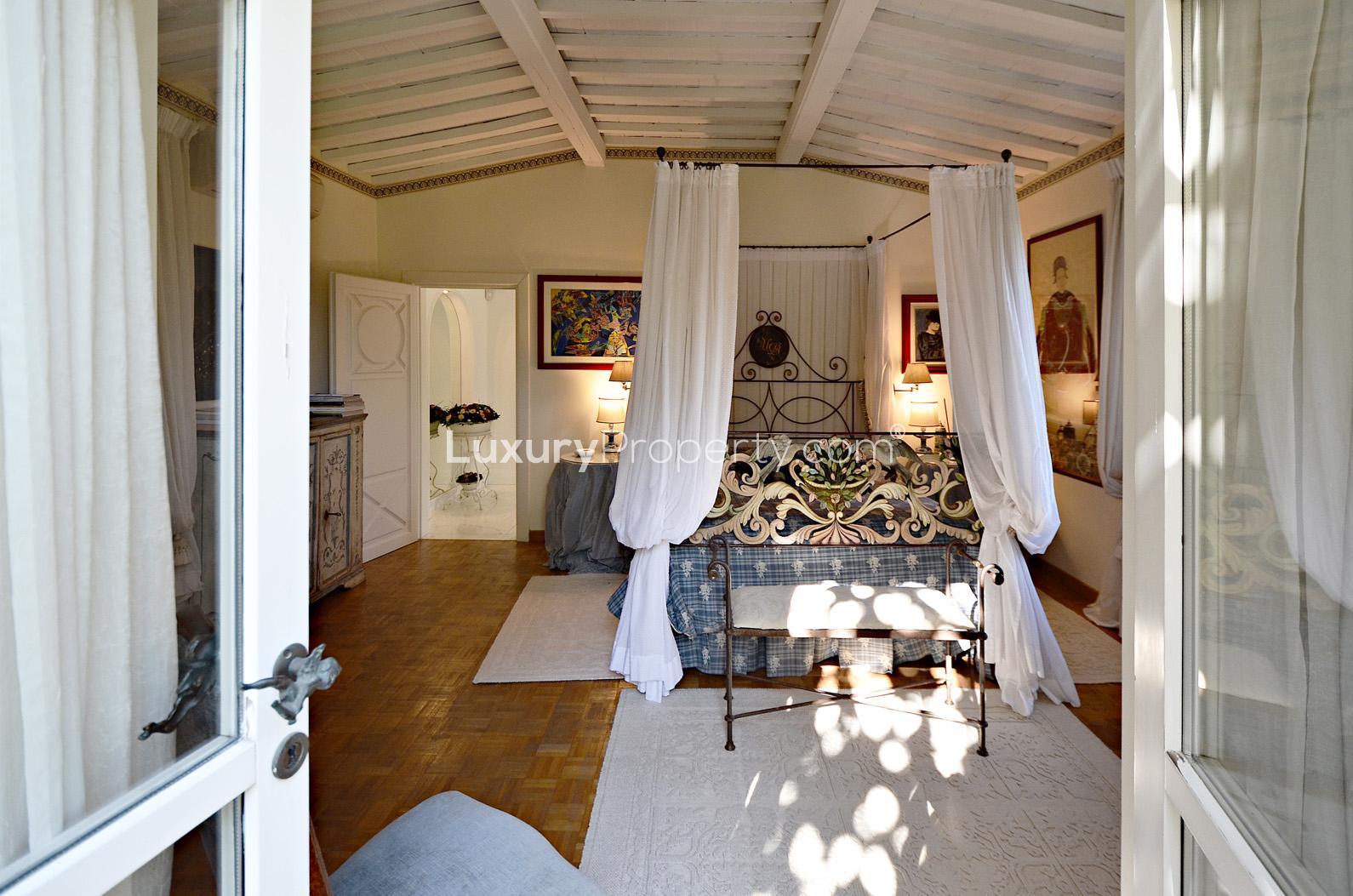 Elegant bedroom in Villa Versilia, Lucca, Italy, showcasing luxurious decor and natural light