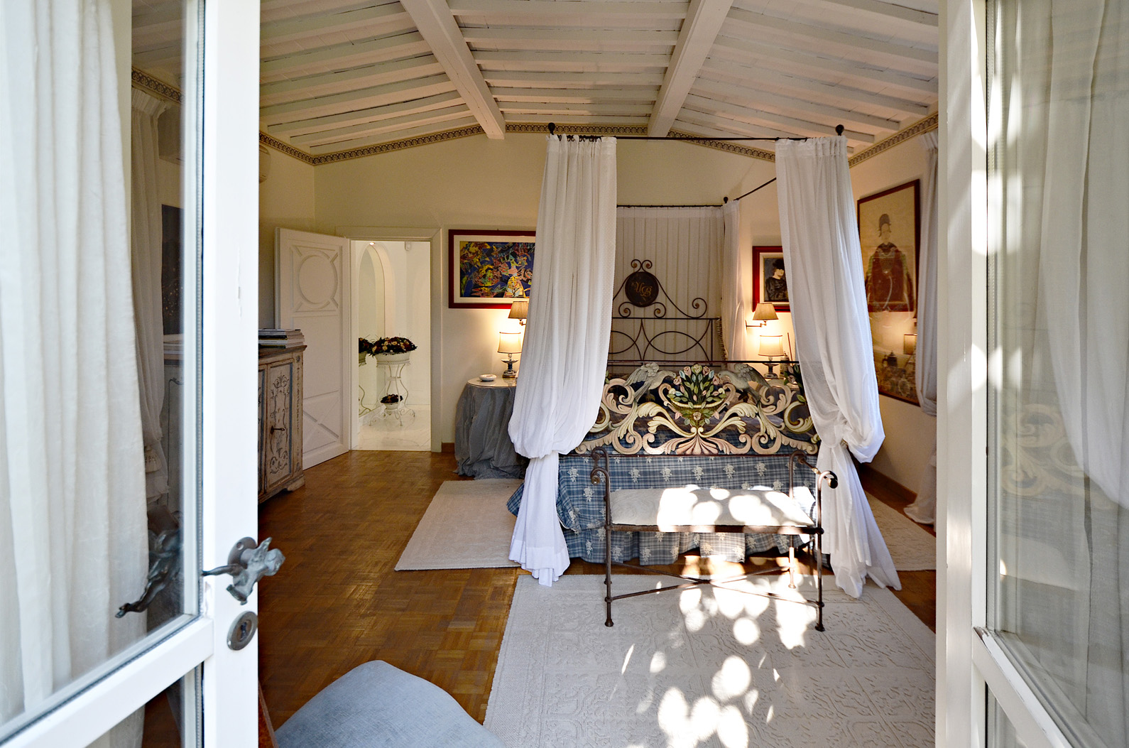 Elegant bedroom in Villa Versilia, Lucca, Italy, showcasing luxurious decor and natural light