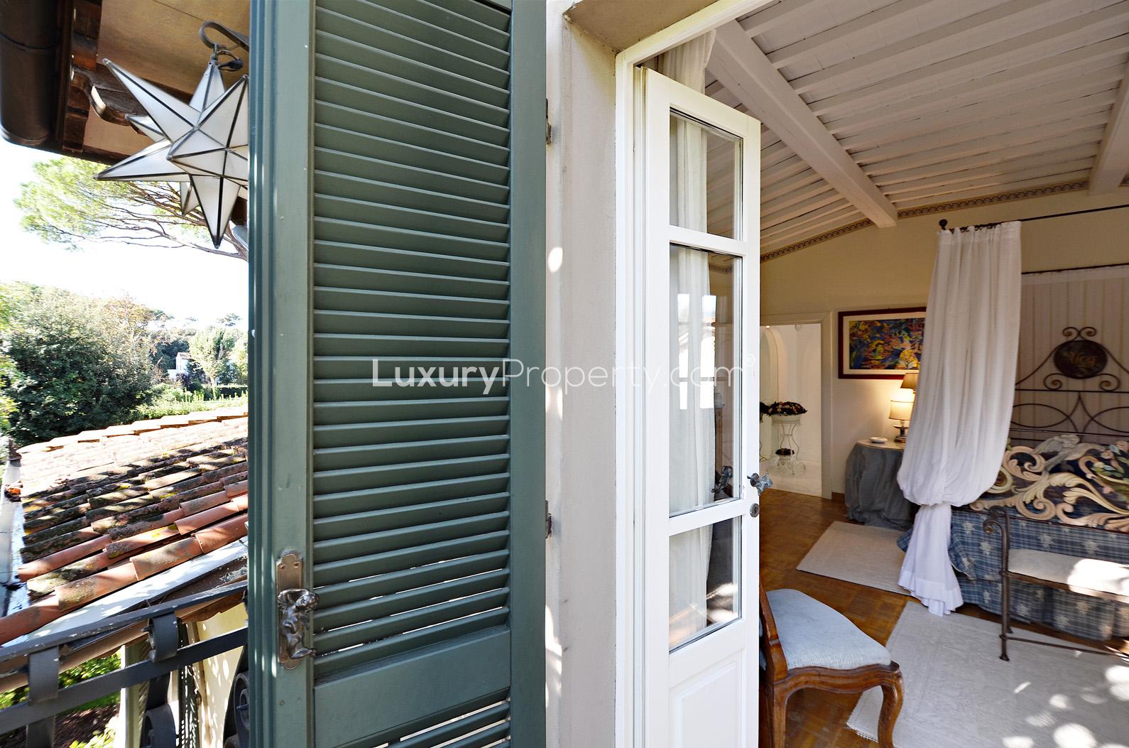 Charming bedroom view in Villa Versilia, Lucca with rustic decor and outdoor access