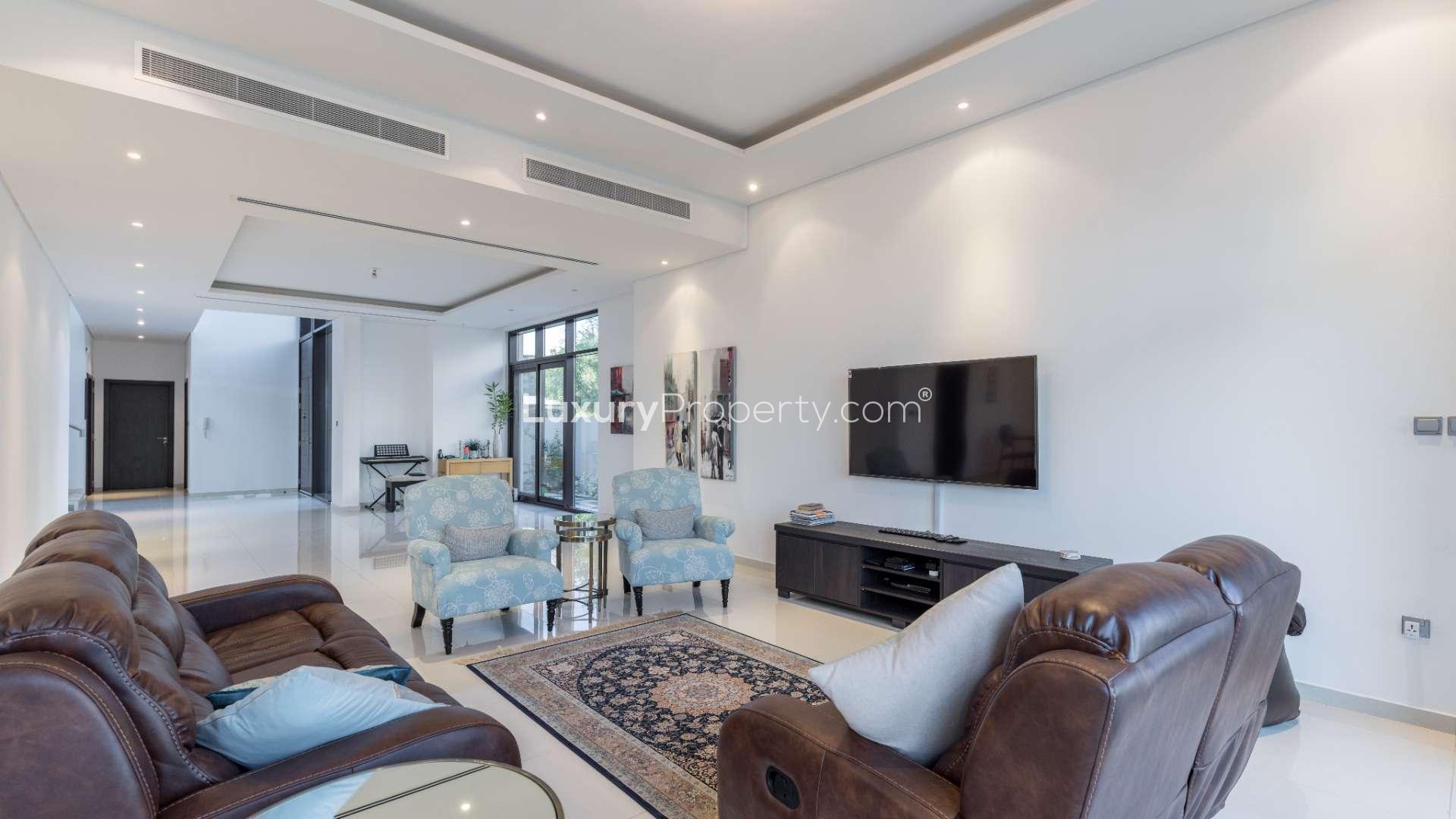 Luxurious living room in Damac Hills villa, featuring elegant leather seating and modern decor