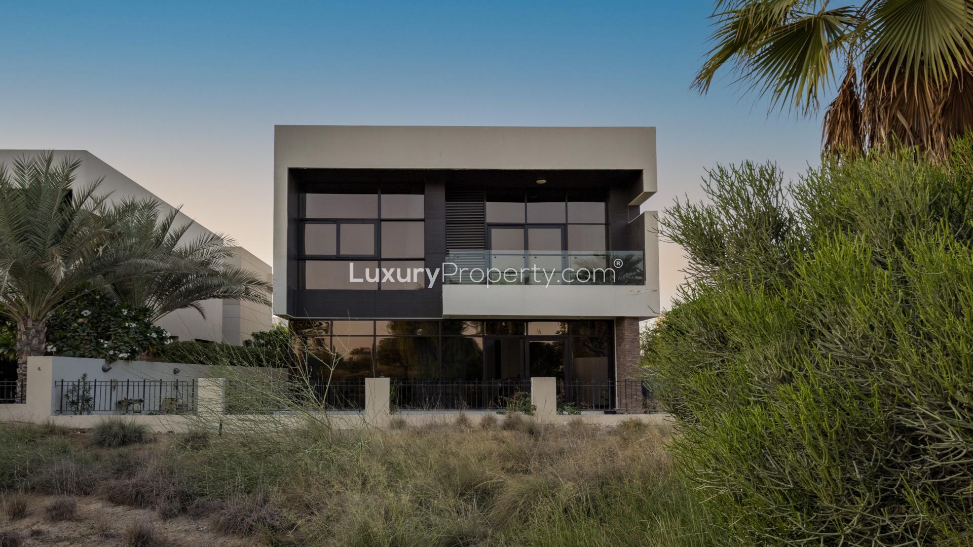 Modern 5-bedroom villa exterior with lush greenery in Damac Hills, Whitefield community