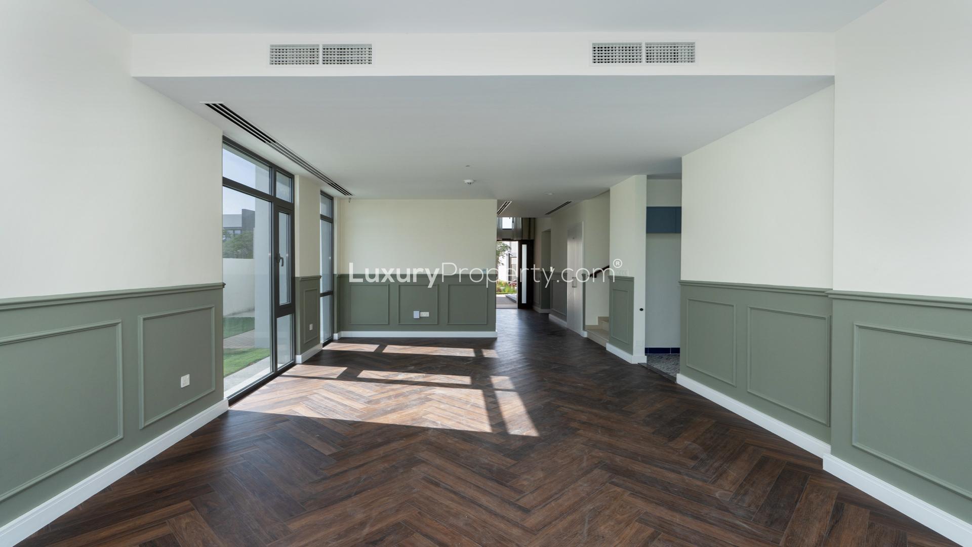 Balcony view of Emaar South Golf Links villa overlooking golf course and modern buildings