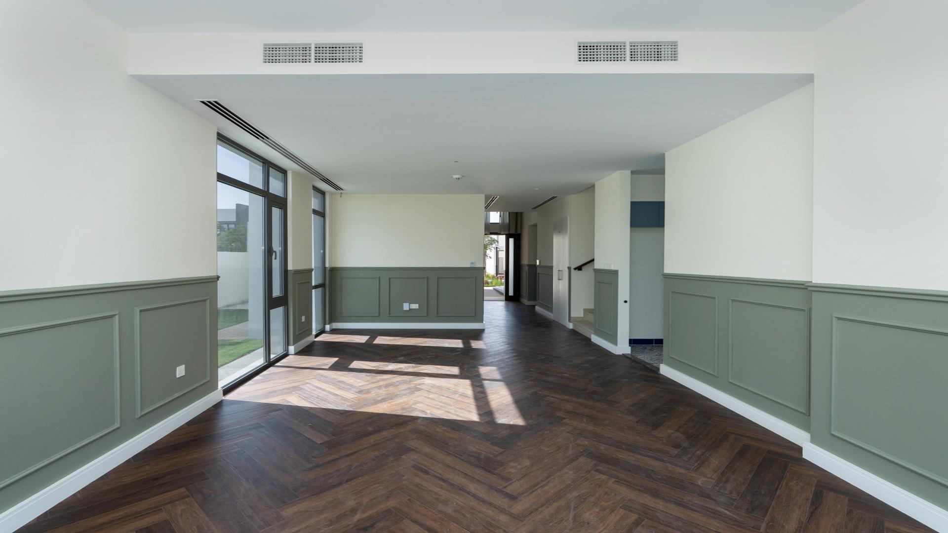 Balcony view of Emaar South Golf Links villa overlooking golf course and modern buildings