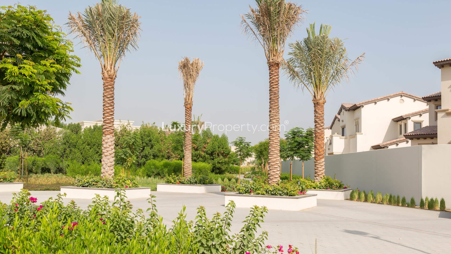 Luxurious villa exterior with palm trees in Yasmin, Arabian Ranches 2 community