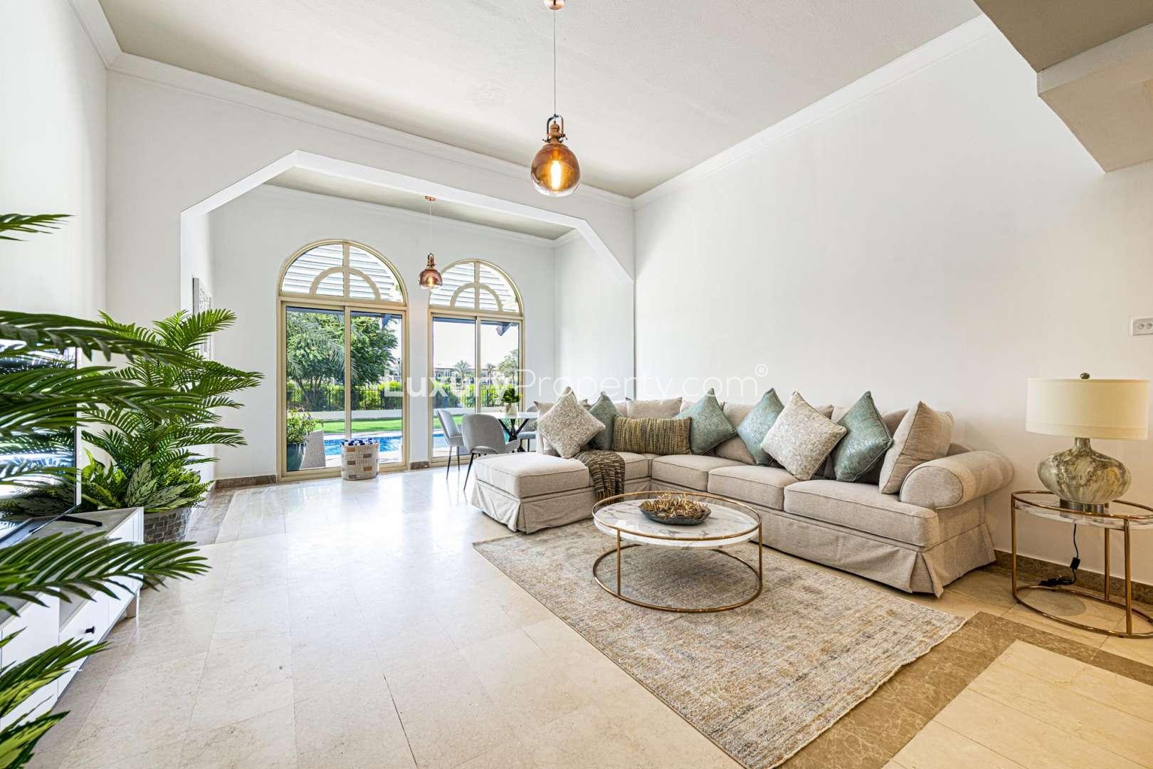 Luxurious Jumeirah Islands villa view with private pool and lush garden scenery