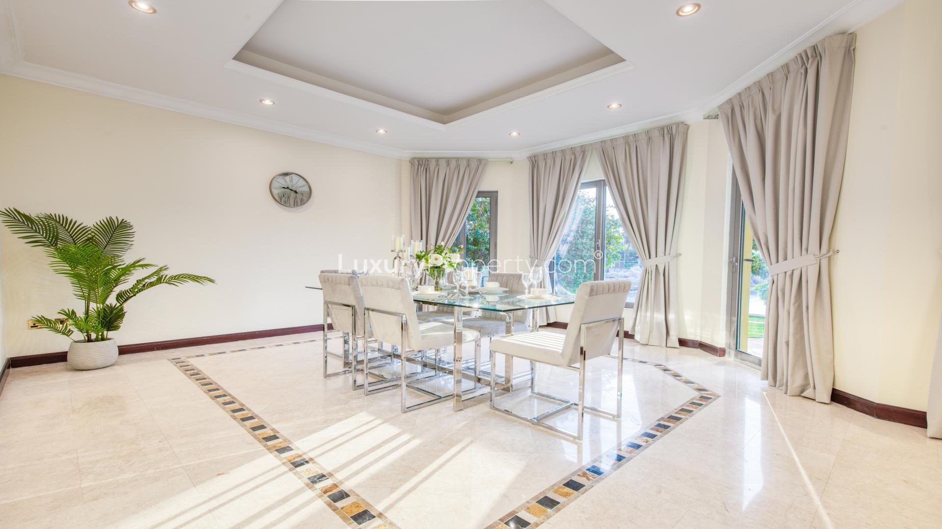 Beachfront villa garden with seating area, overlooking private beach in Palm Jumeirah