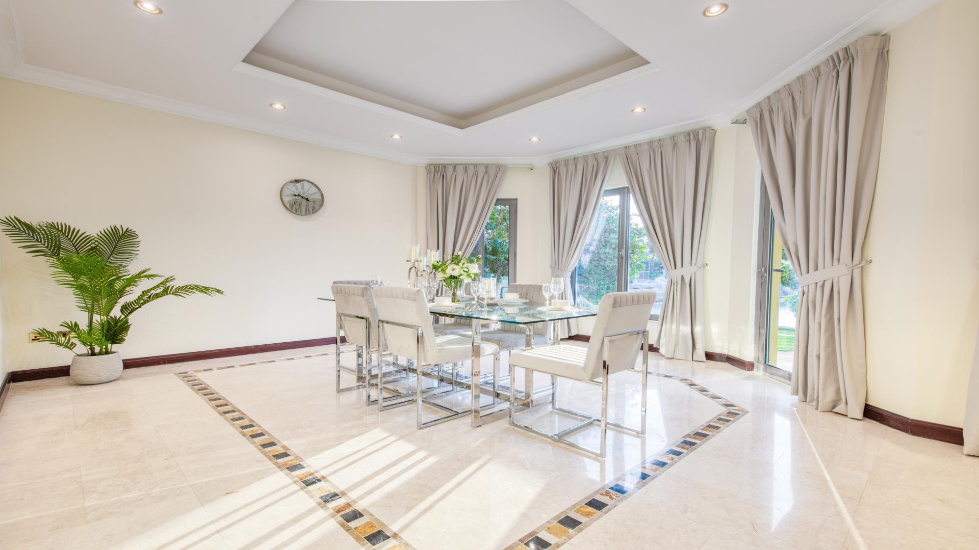 Beachfront villa garden with seating area, overlooking private beach in Palm Jumeirah