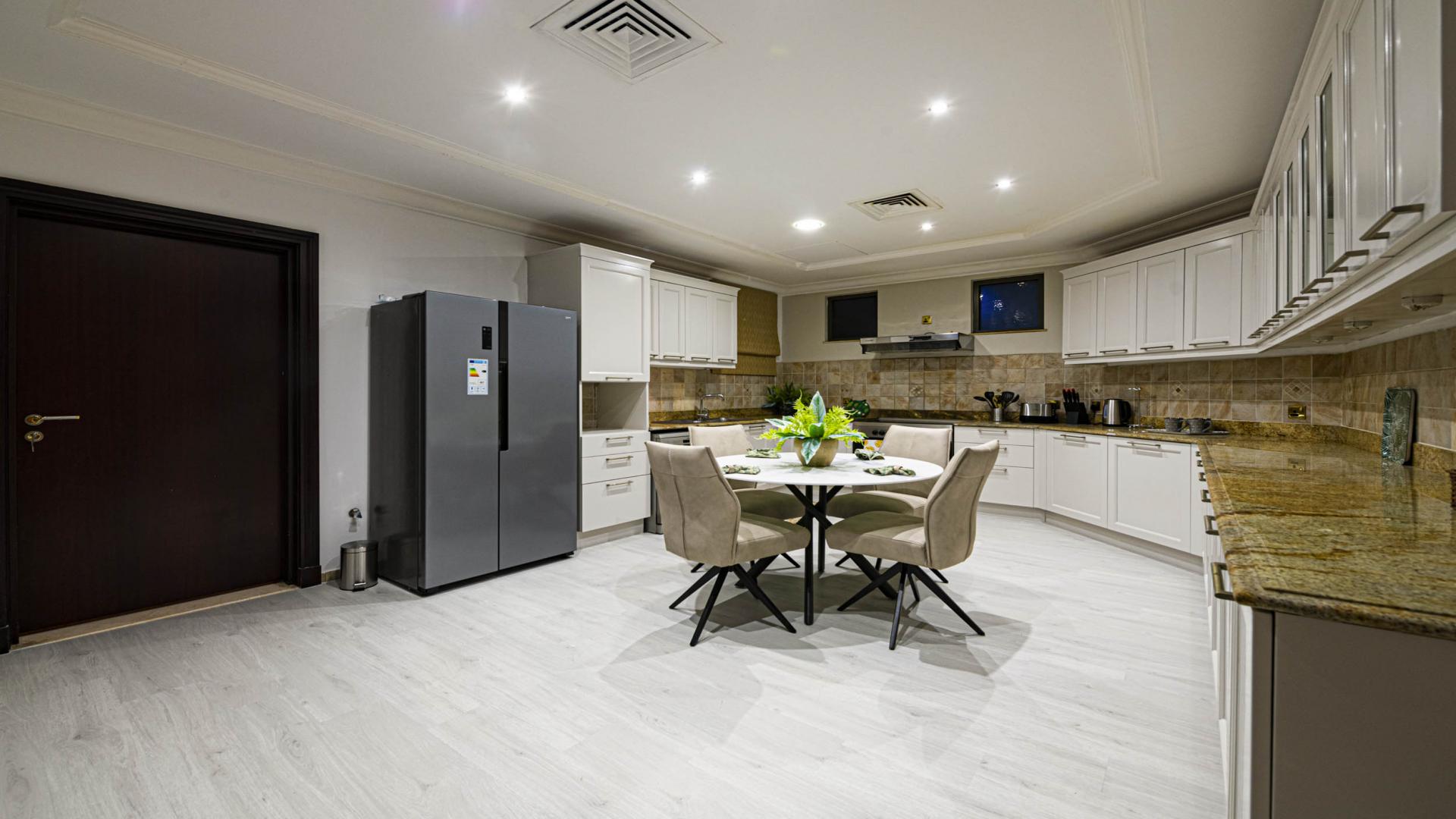 Dining room in luxury Atrium Villa, Palm Jumeirah, featuring elegant decor and modern lighting