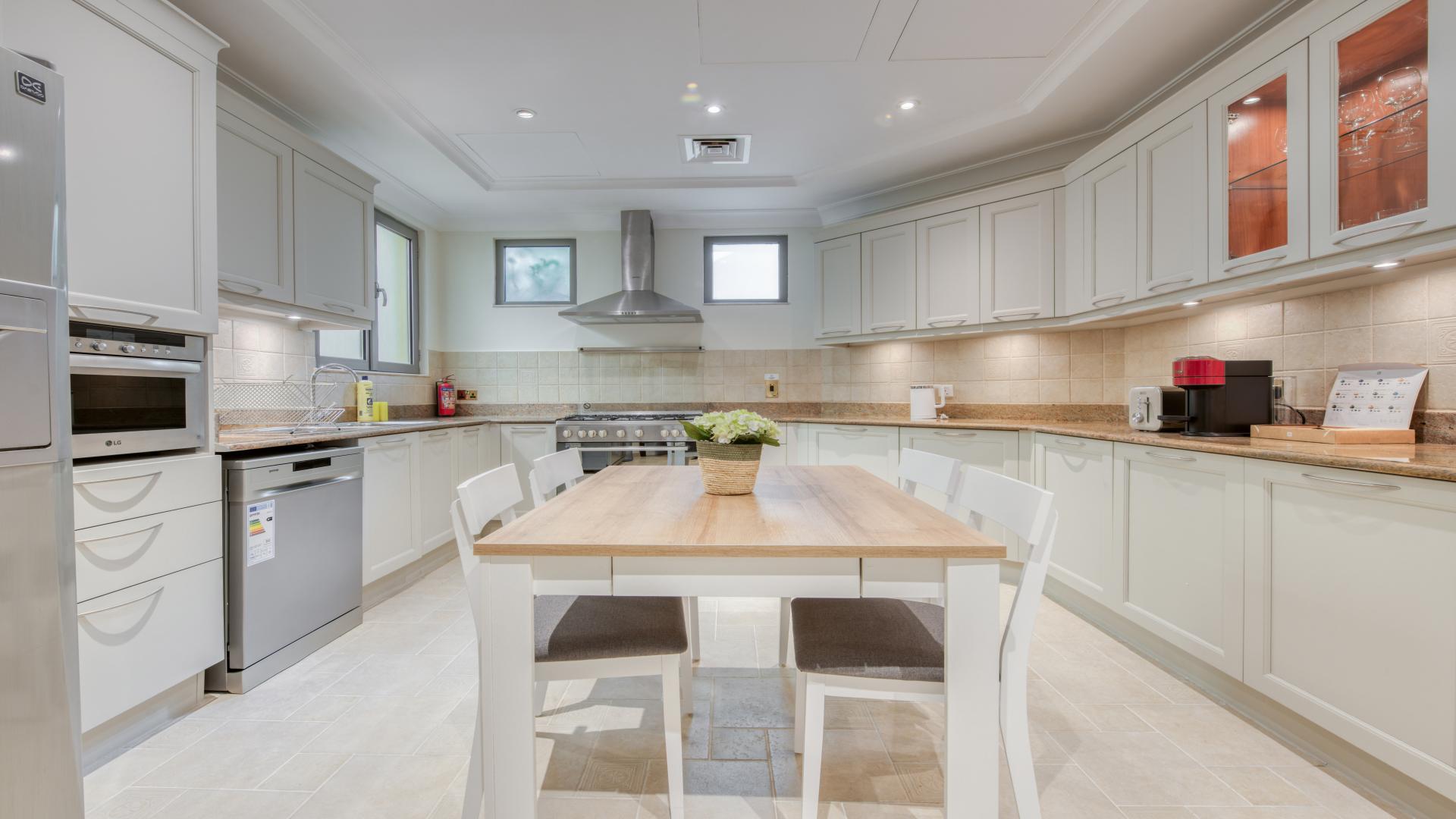 Contemporary villa foyer with elegant chandelier and artwork, Palm Jumeirah Garden Homes