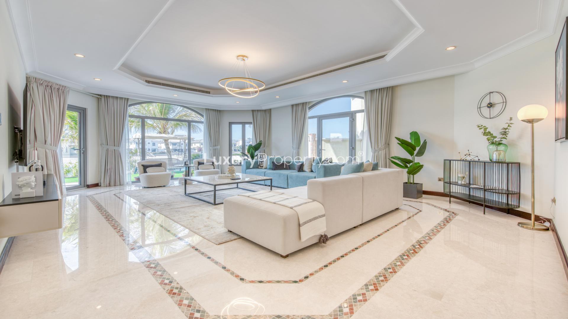 Elegant dining area in contemporary villa on Palm Jumeirah with pool and beach view