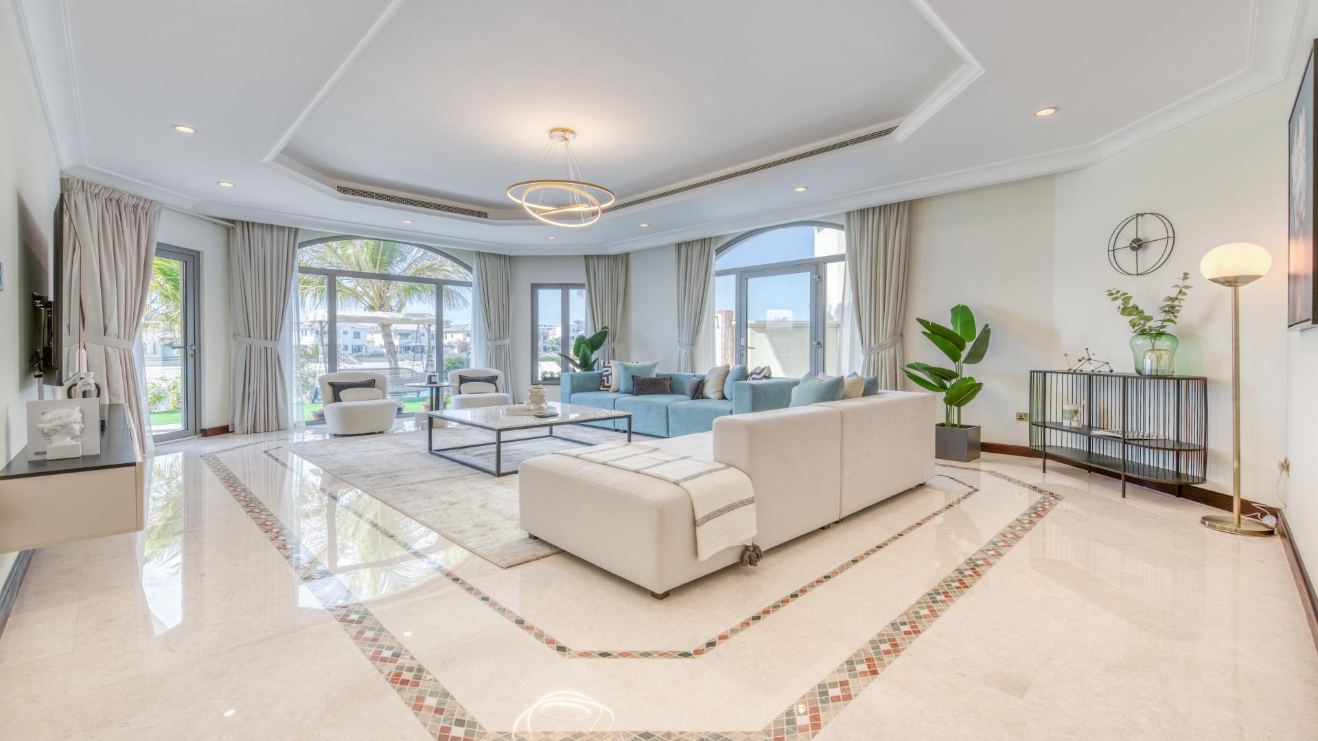 Elegant dining area in contemporary villa on Palm Jumeirah with pool and beach view