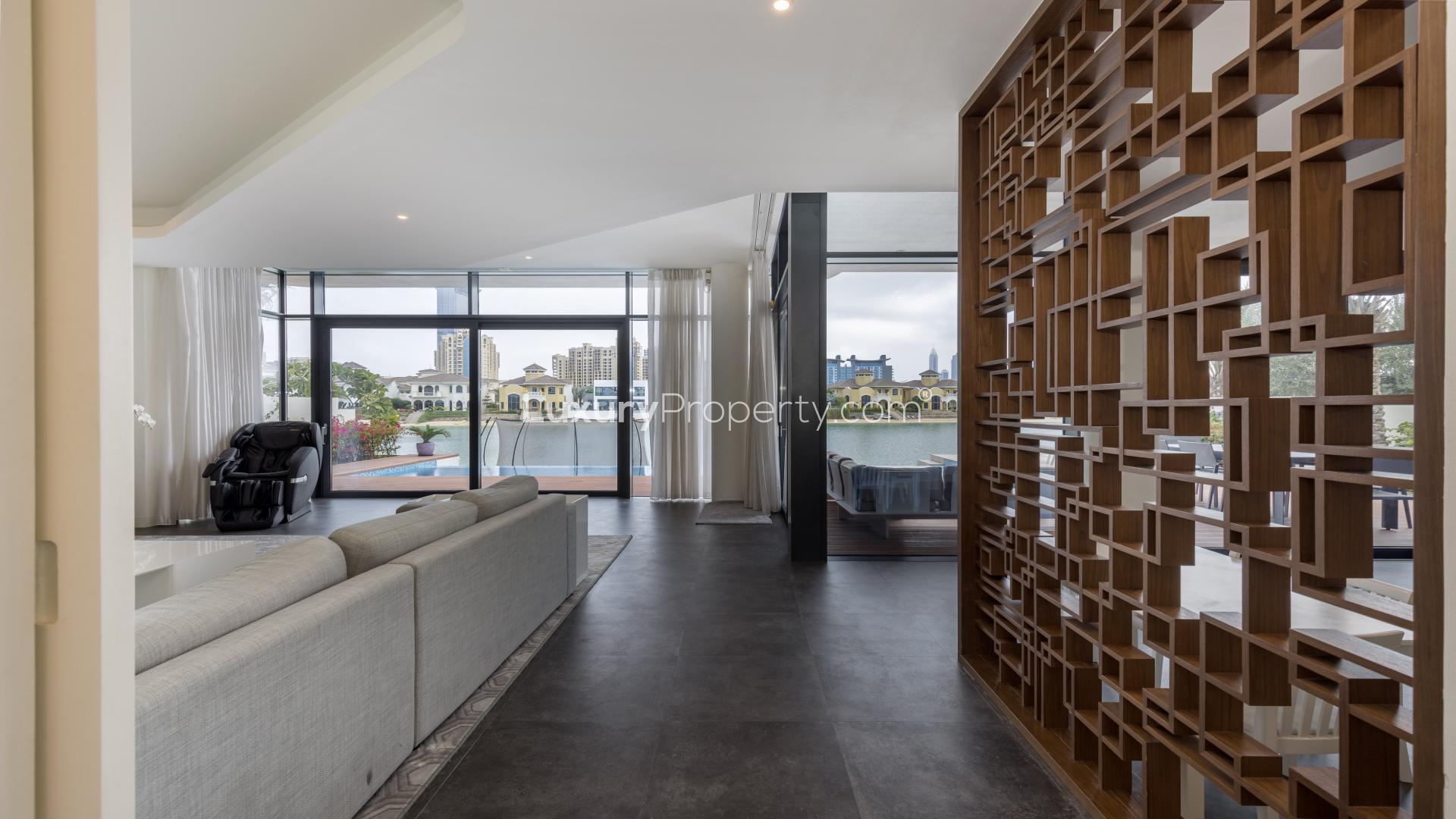Modern living room in Palm Jumeirah villa with treadmill and large windows