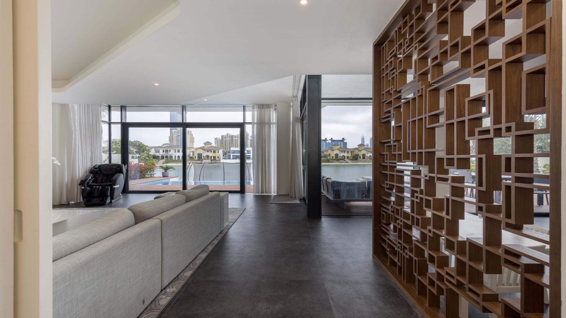 Modern living room in Palm Jumeirah villa with treadmill and large windows