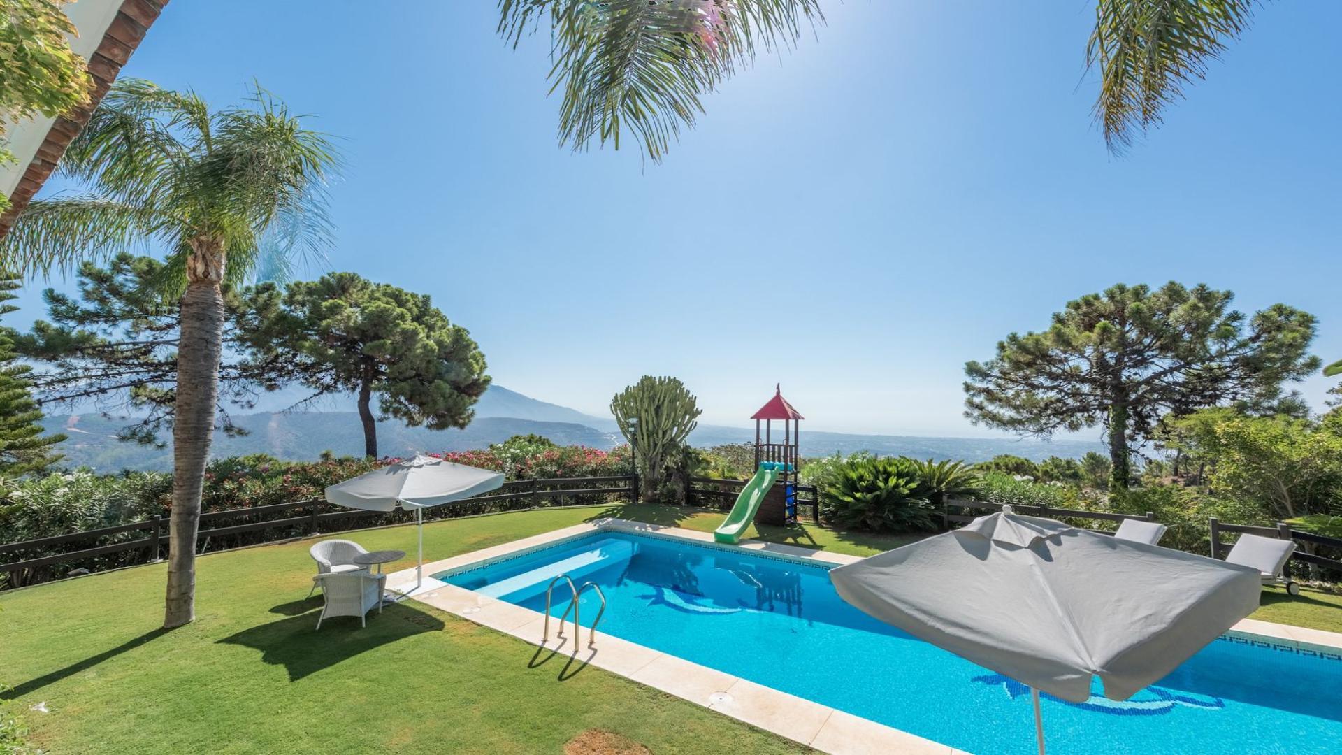 Luxurious villa pool with sea views in La Zagaleta, Málaga, surrounded by lush greenery