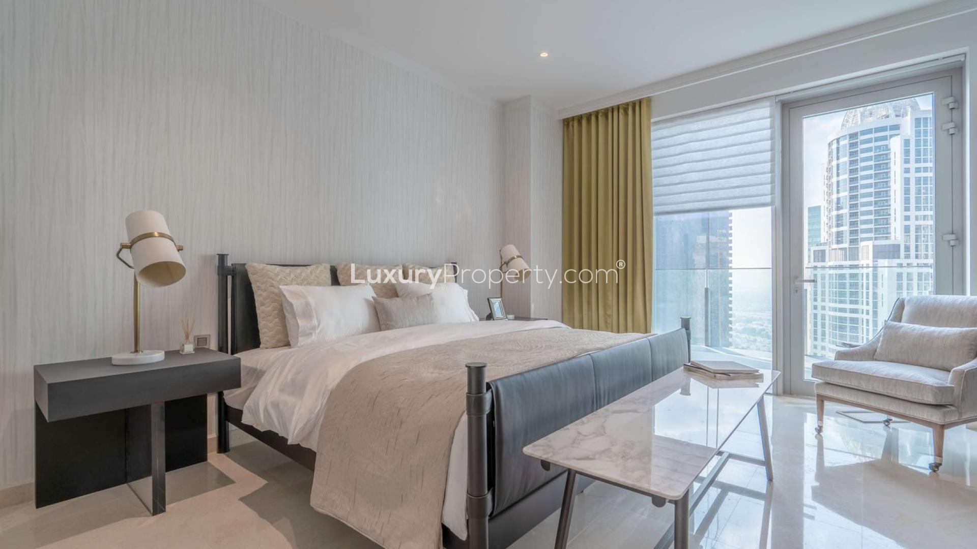 Modern living area in three-bedroom apartment, The Residences JLT, with city skyline views