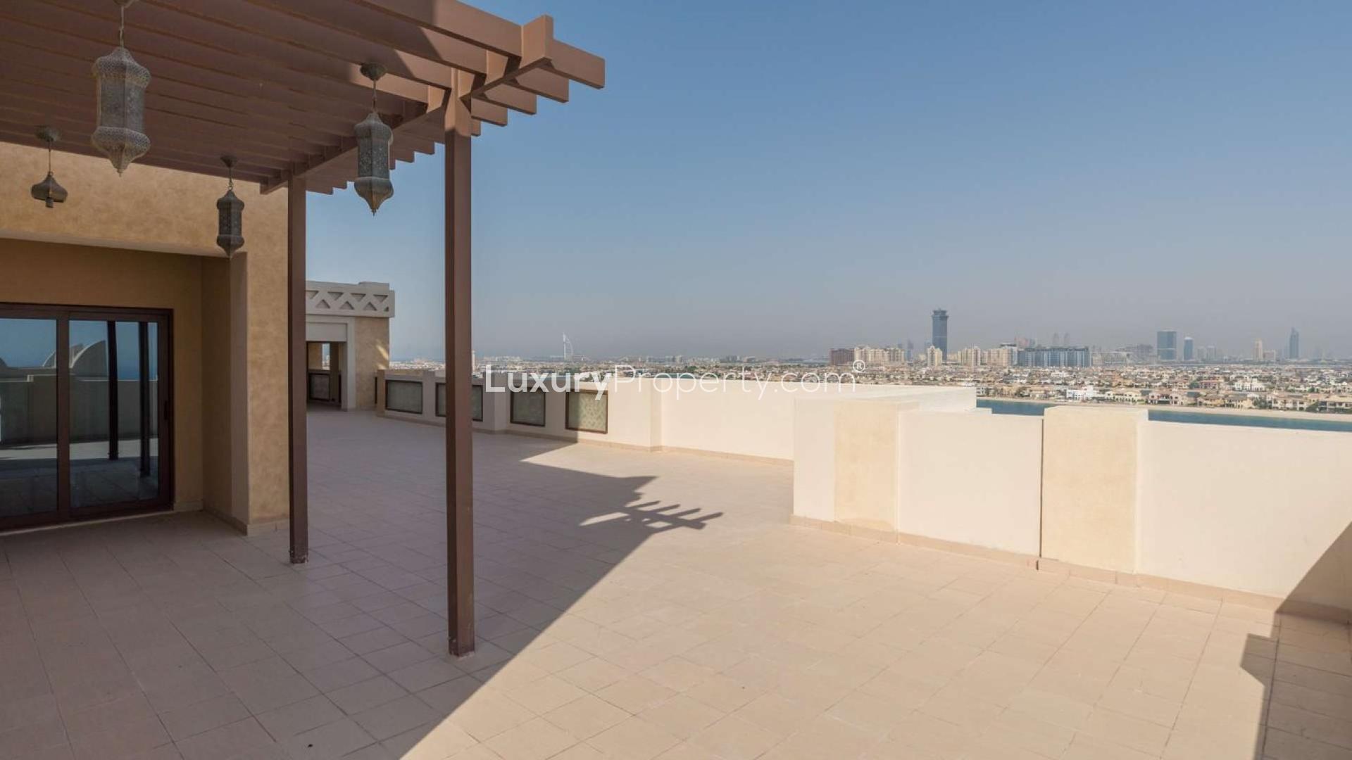 "Stunning sea view from Royal Duplex Penthouse in Palm Jumeirah, Kingdom of Sheba.","Spacious terrace view from Royal Duplex Penthouse in Palm Jumeirah, Kingdom of Sheba.","Spacious terrace with stunning sea view at Royal Duplex Penthouse, Palm Jumeirah.",Luxurious bedroom in Palm Jumeirah penthouse, featuring elegant decor and ample natural light