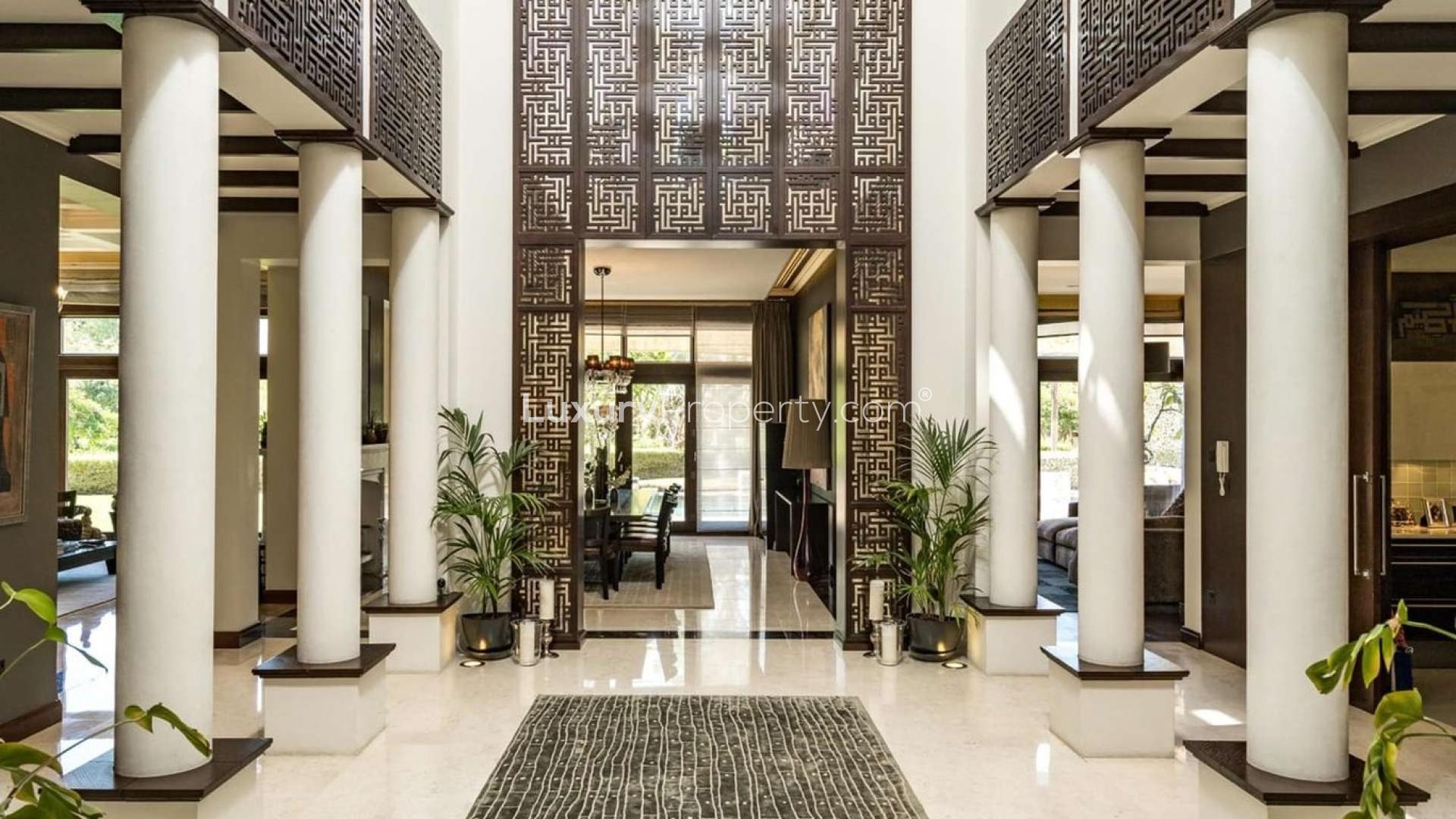 Luxurious Mediterranean villa entrance with elegant columns in Al Barari, Desert Leaf 5
