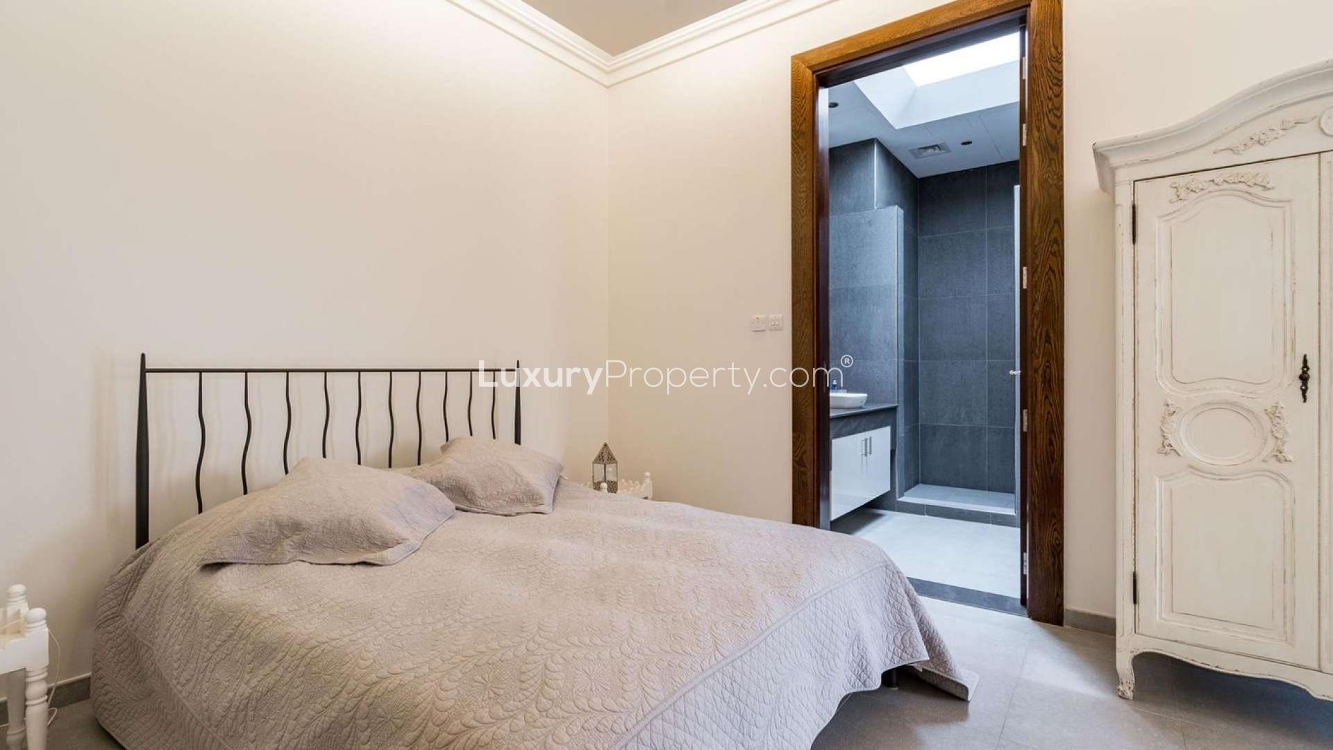 Luxurious living room in Al Barari villa, elegant decor, spacious seating area, natural light