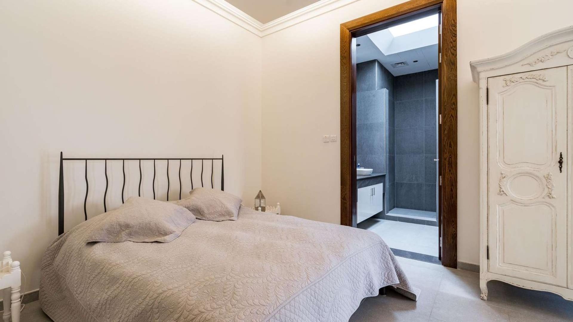 Luxurious living room in Al Barari villa, elegant decor, spacious seating area, natural light