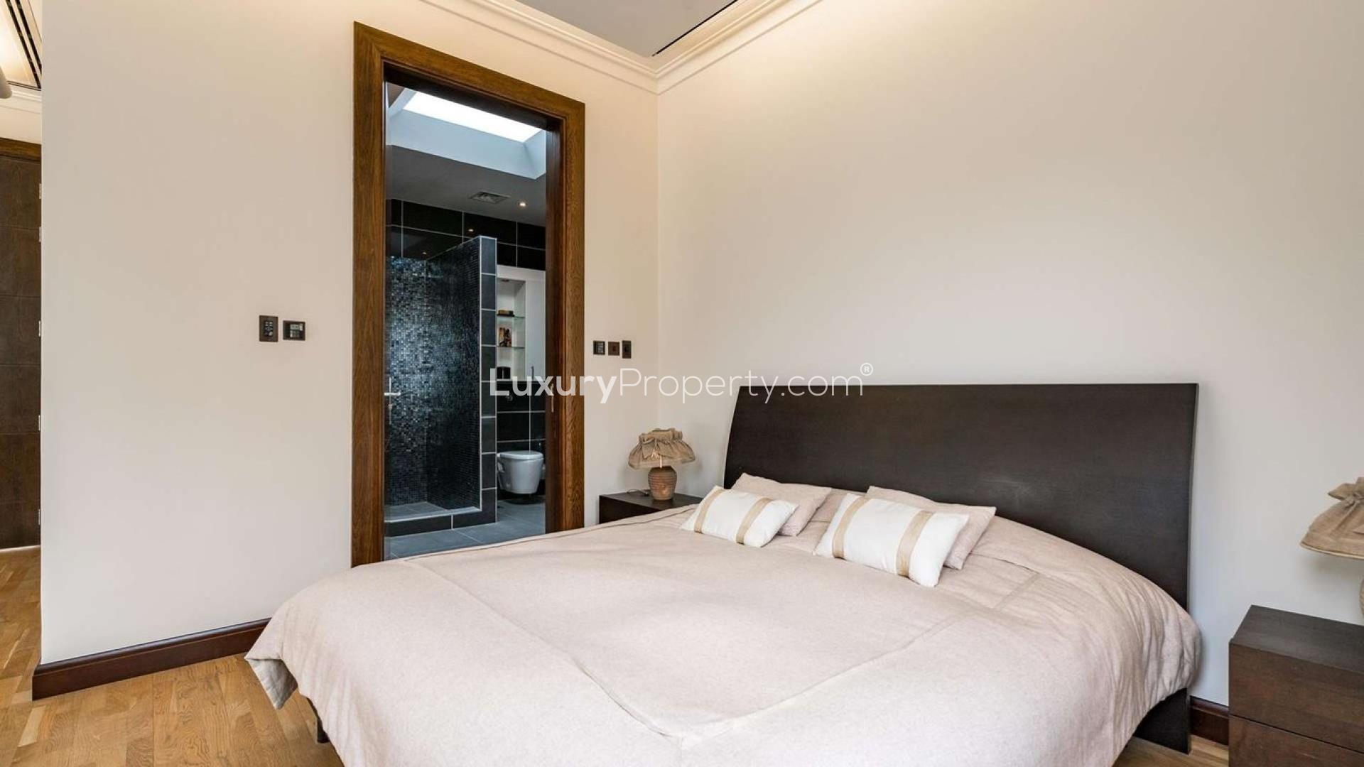 Impeccable 6-bedroom villa exterior in Al Barari, featuring lush garden and spacious driveway