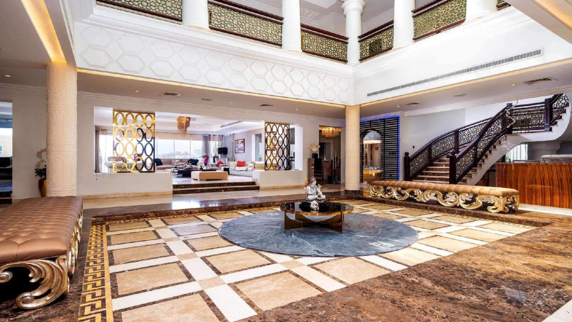 Luxurious interior of 6-bedroom Fendi mansion in Emirates Hills, featuring elegant staircase and decor
