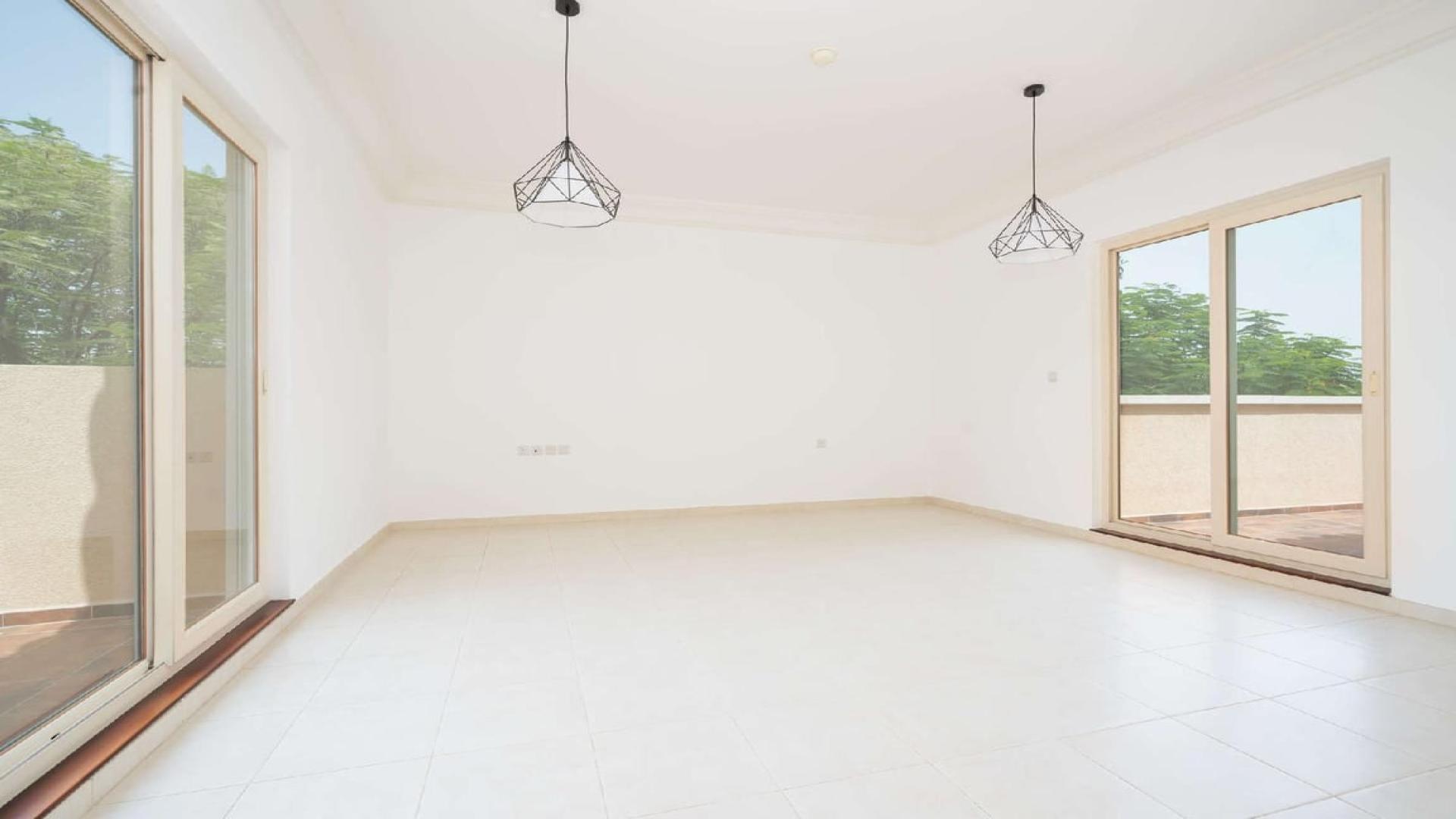 Bright living area with garden views in Victory Heights villa, Dubai Sports City