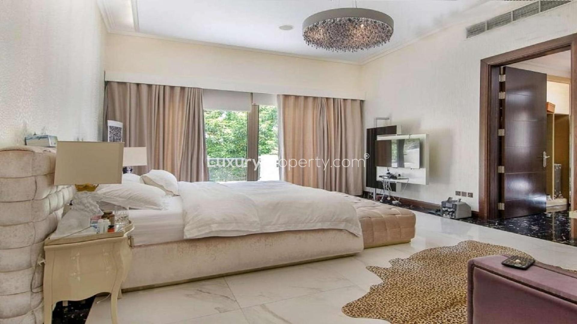 Luxurious hallway in 6-bedroom Dahlia Villa, Al Barari, featuring elegant decor and artwork