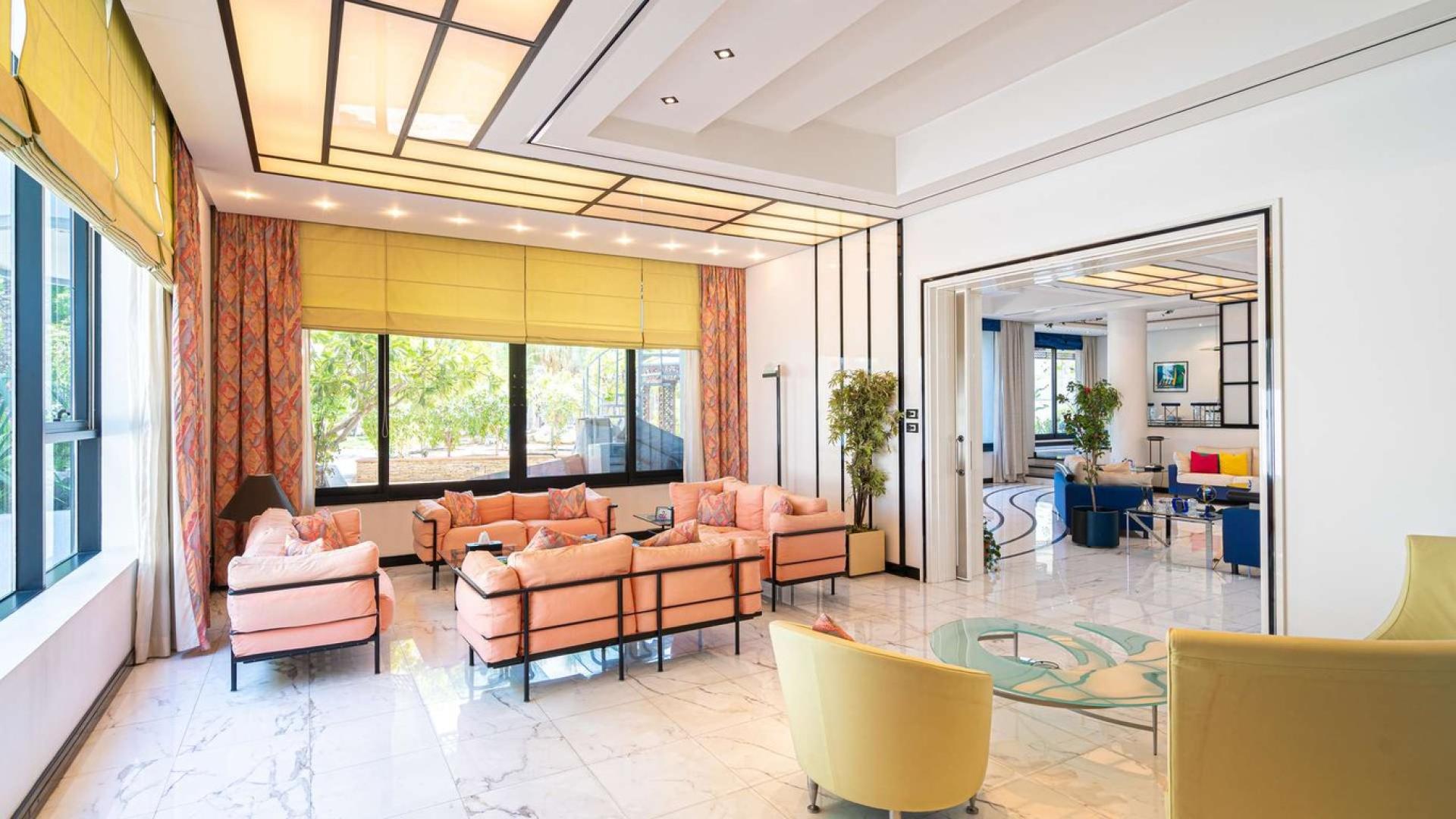 Luxurious living room in six-bedroom villa, Al Manara, Dubai, with modern furnishings and decor