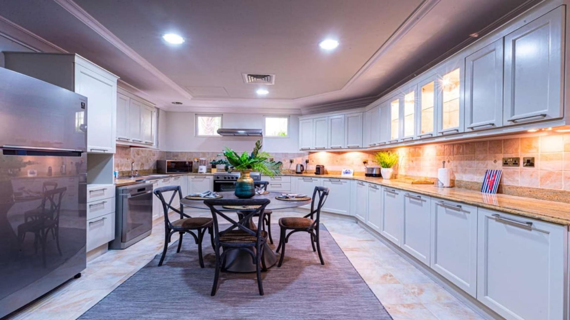 Beautiful Malibu-style villa in Palm Jumeirah's Garden Homes with lush landscaping