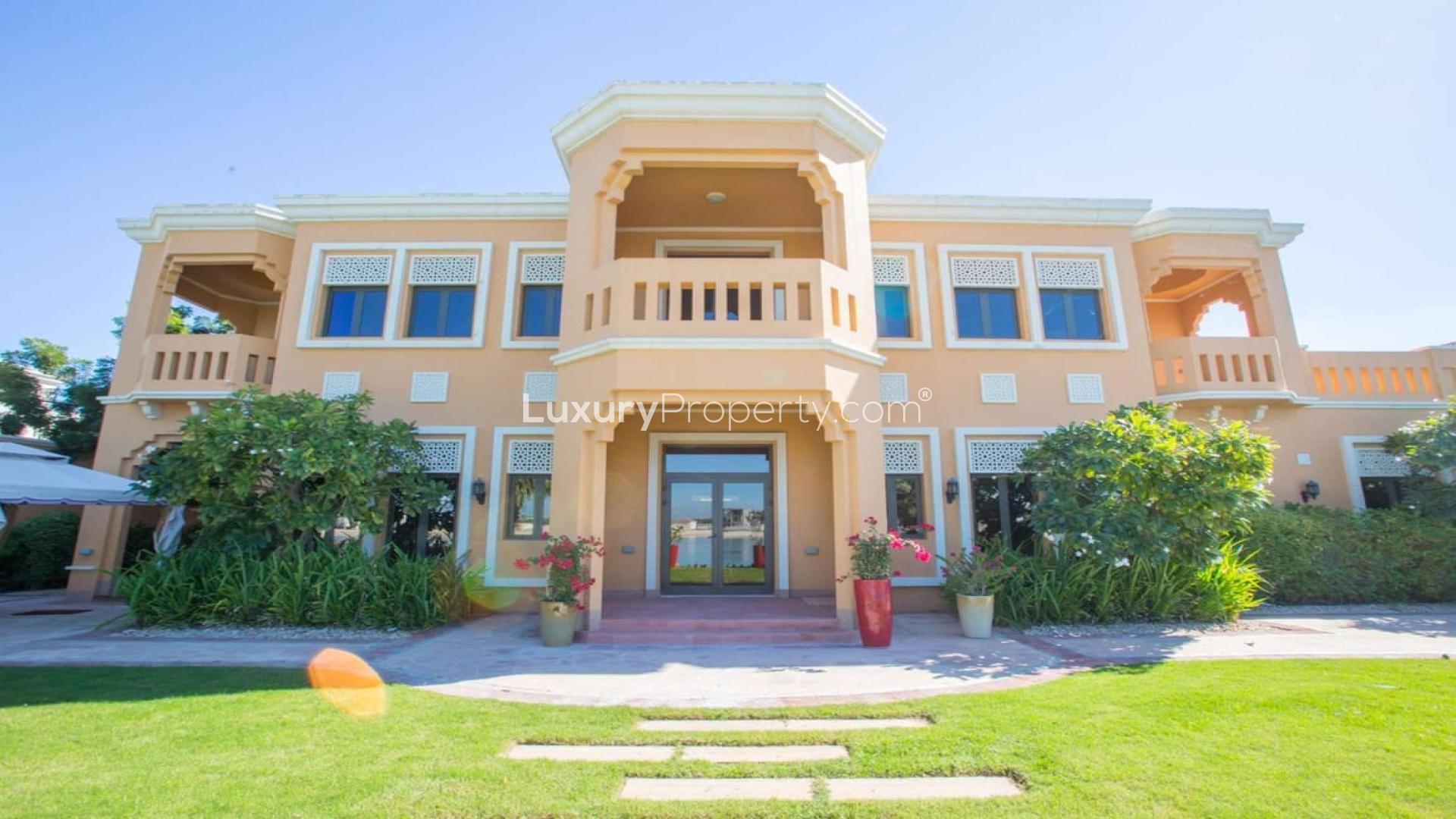 Exceptional Signature Villa facade with lush garden on Palm Jumeirah for rent