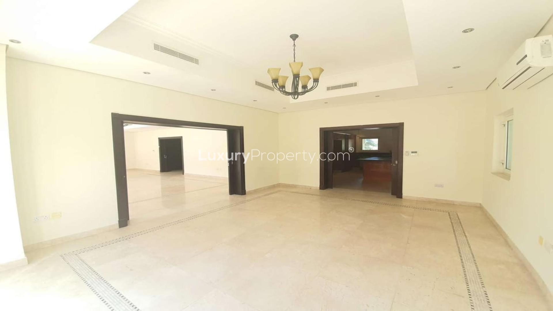 Spacious 6-bedroom villa exterior with palm trees in Al Furjan, North Village for rent
