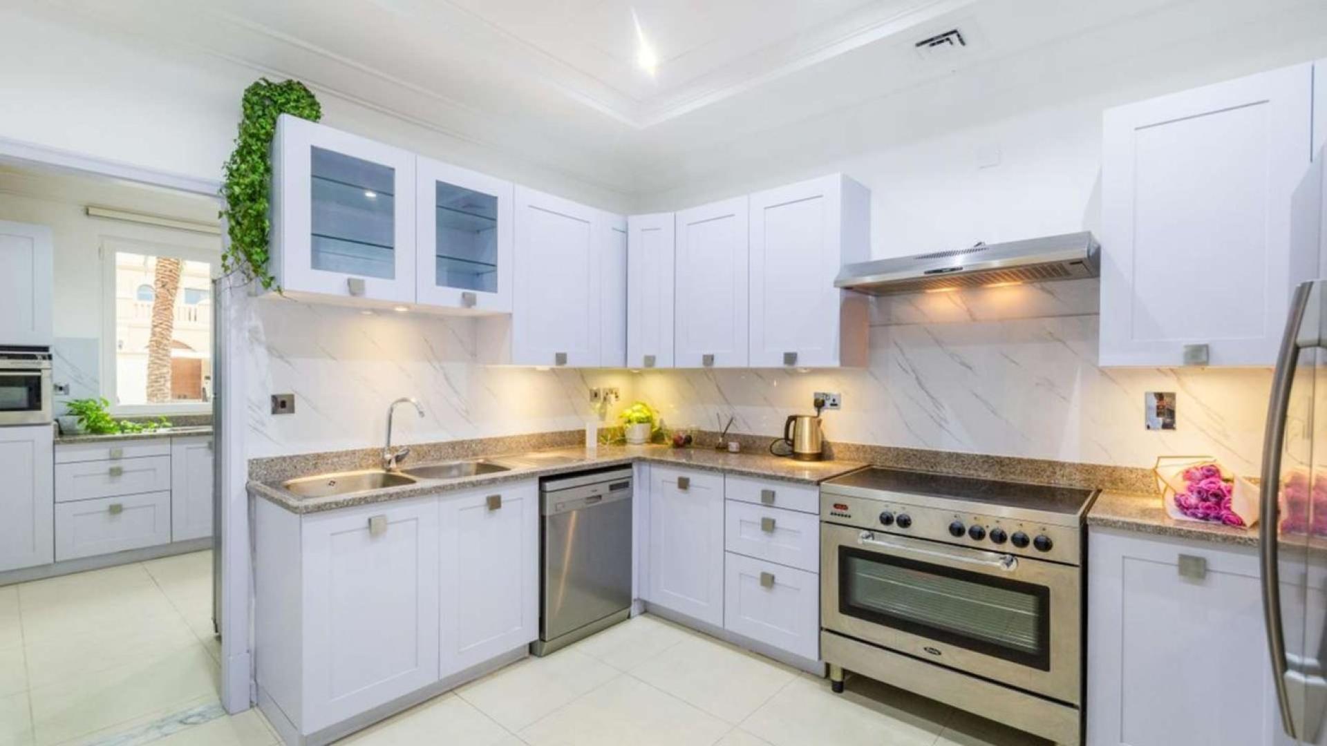 Beautiful villa lawn with colorful bean bags, waterfront view, Palm Jumeirah Signature Villas