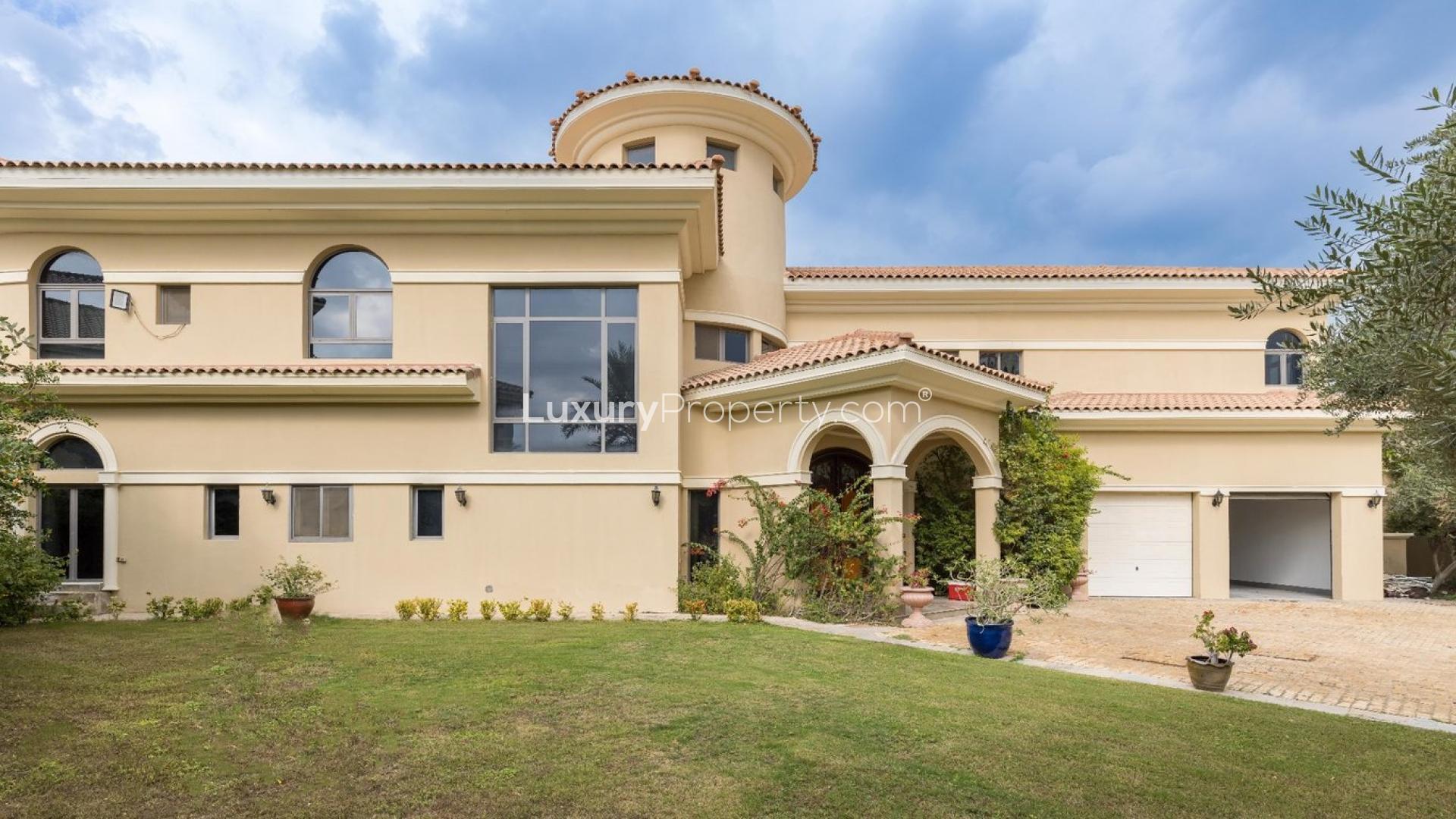Luxurious entryway of Palm Jumeirah villa with elegant columns and chandelier