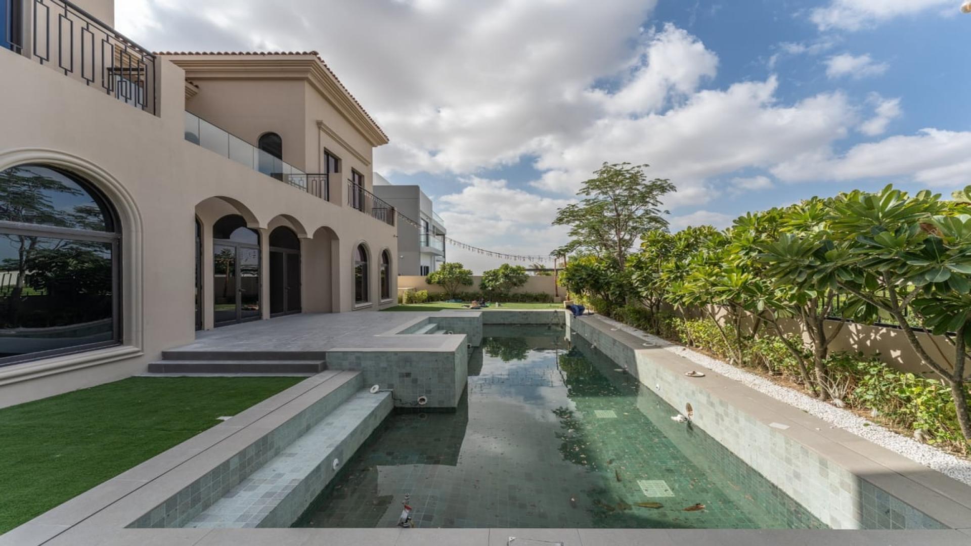 Spacious living room with large windows in Dubai Hills Estate villa for rent