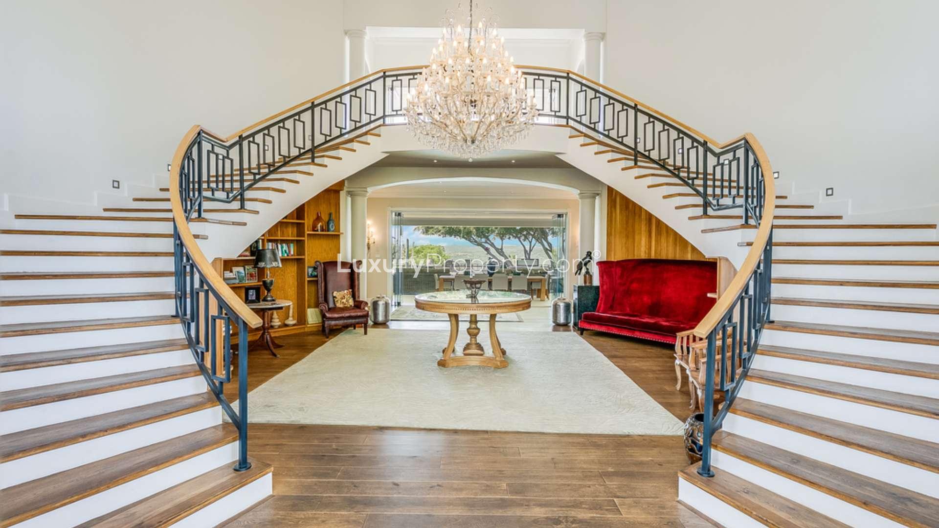 Luxurious living room in 6-bedroom Georgian manor, Bryanston, featuring elegant decor and fireplace