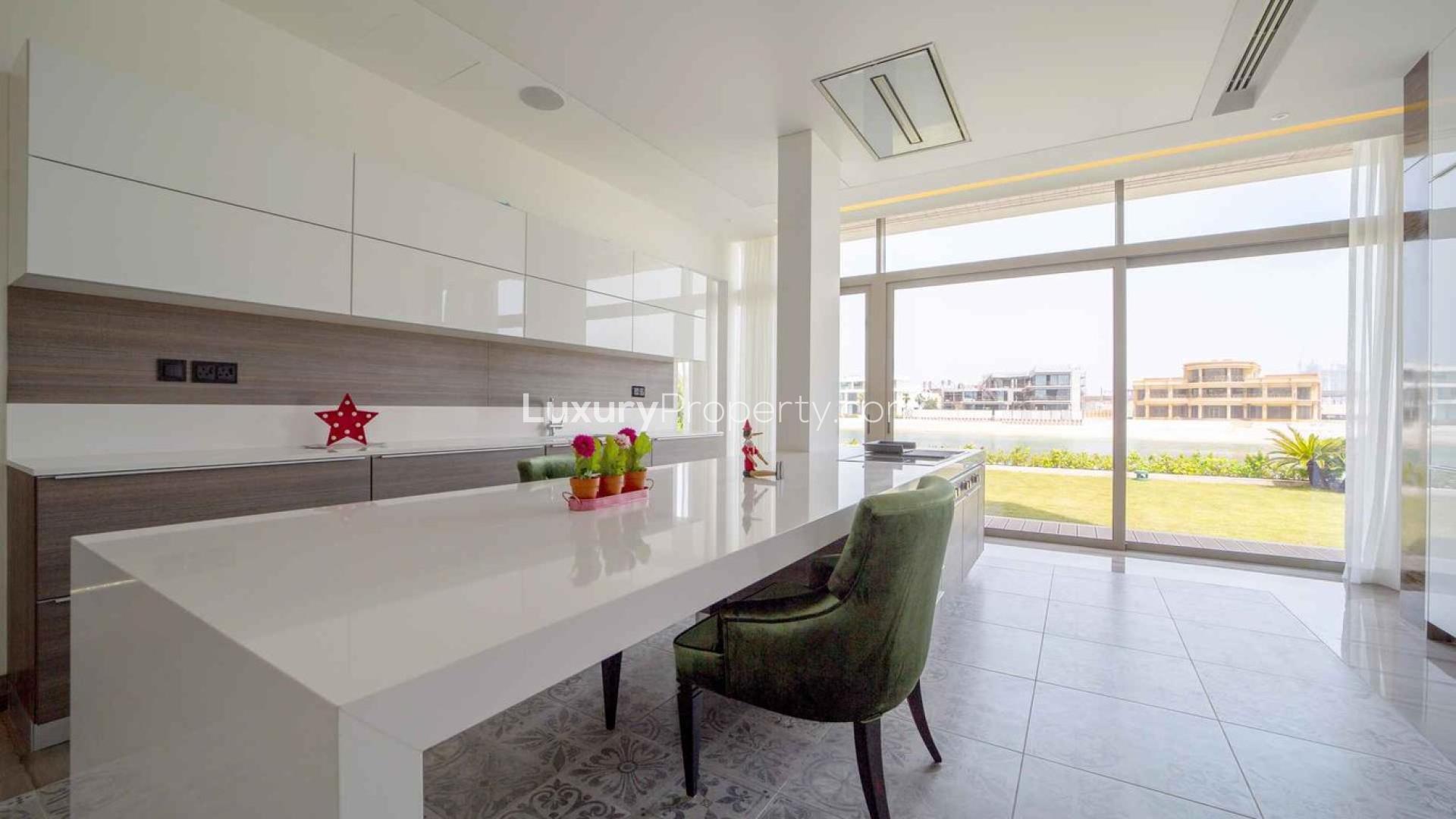"Modern kitchen in bespoke Palm Jumeirah villa with garden view, LP01489 for sale.",Spacious living area with floor-to-ceiling windows in Palm Jumeirah villa, Signature Villas