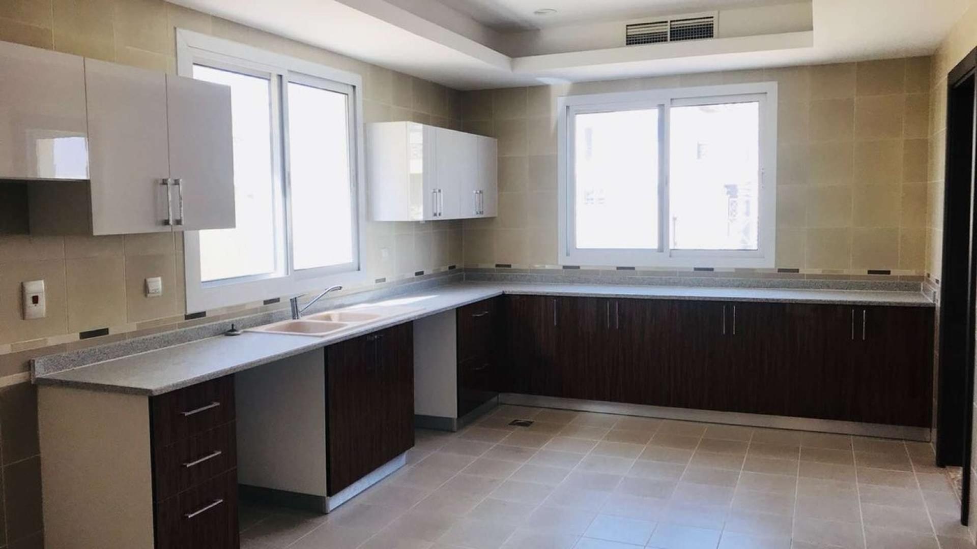 Spacious 6-bedroom villa exterior in Living Legends, B Villas, with gated entrance and balcony