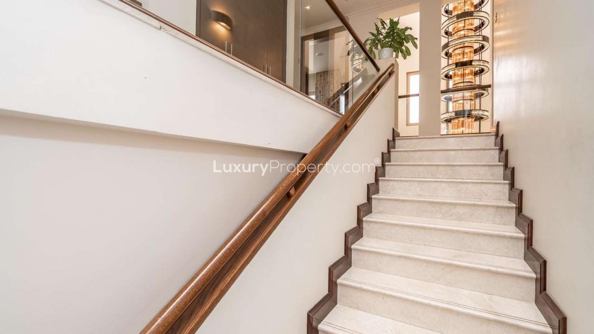 Luxurious living room in 6-bedroom villa, Al Barari, Dubai with modern decor and garden view